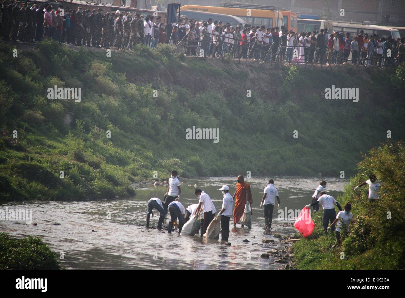Kathmandu, Nepal. 11th Apr, 2015. Nepalese people pick up rubbish on the Bagmati river to mark the 100th week of the Bagmati Clean-up Campaign in Kathmandu, Nepal, April 11, 2015. A sea of people thronged the Bagmati river to form a human chain from Sundarijal to Chobar in order to convey a message that the holy river is no longer a dumping site. Credit:  Sunil Sharma/Xinhua/Alamy Live News Stock Photo