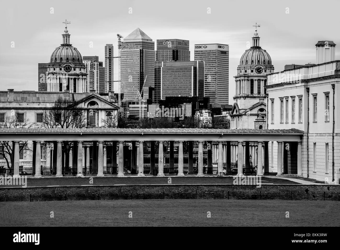 The view from Greenwich Park towards the Old Naval College set in front of the modern Canary Wharf, in black and white Stock Photo