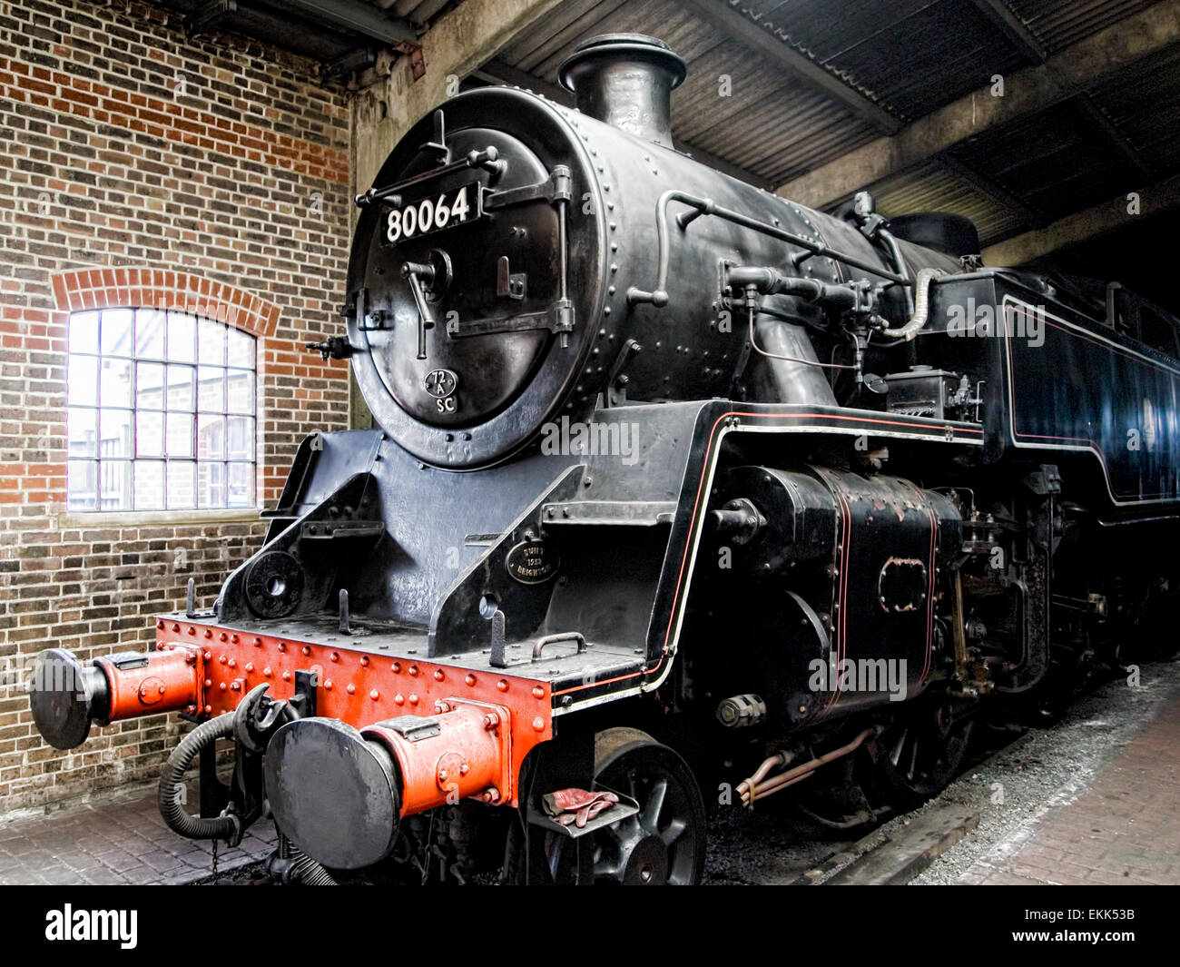 Black steam locomotive in engine shed Stock Photo
