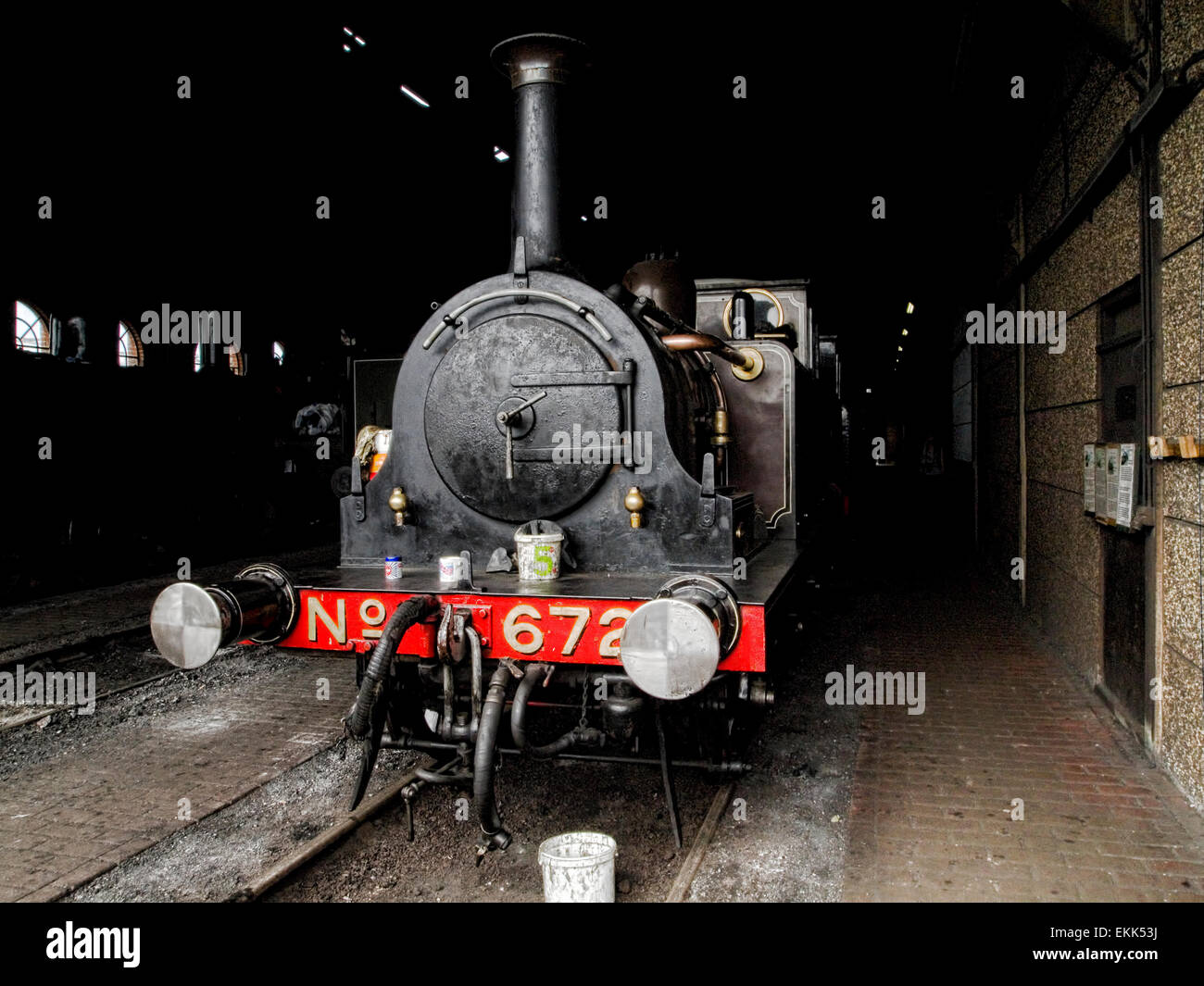 Front of old steam locomotive in engine shed Stock Photo