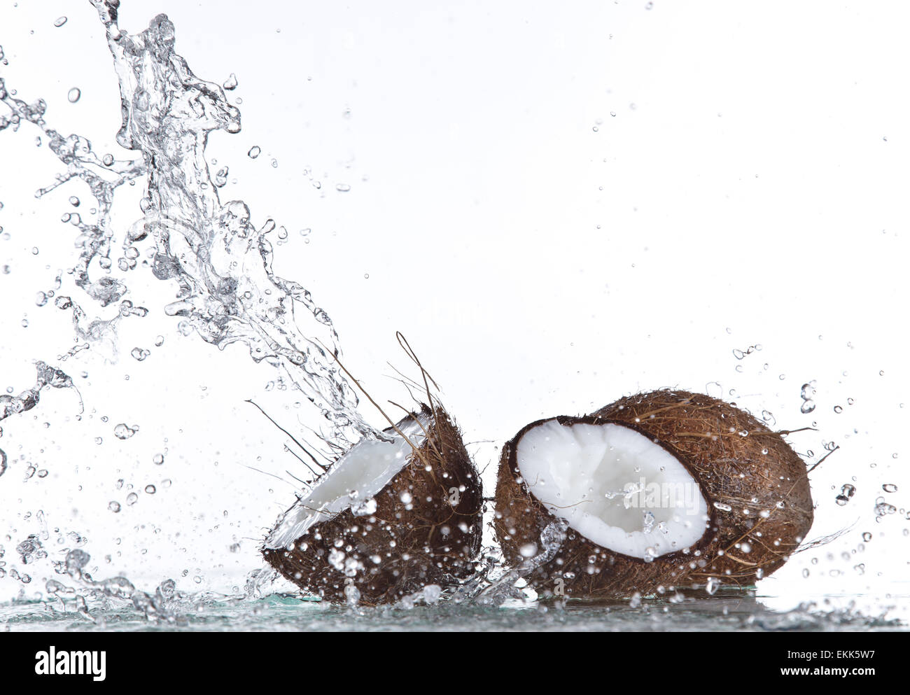 Coconuts with water splash isolated on white Stock Photo