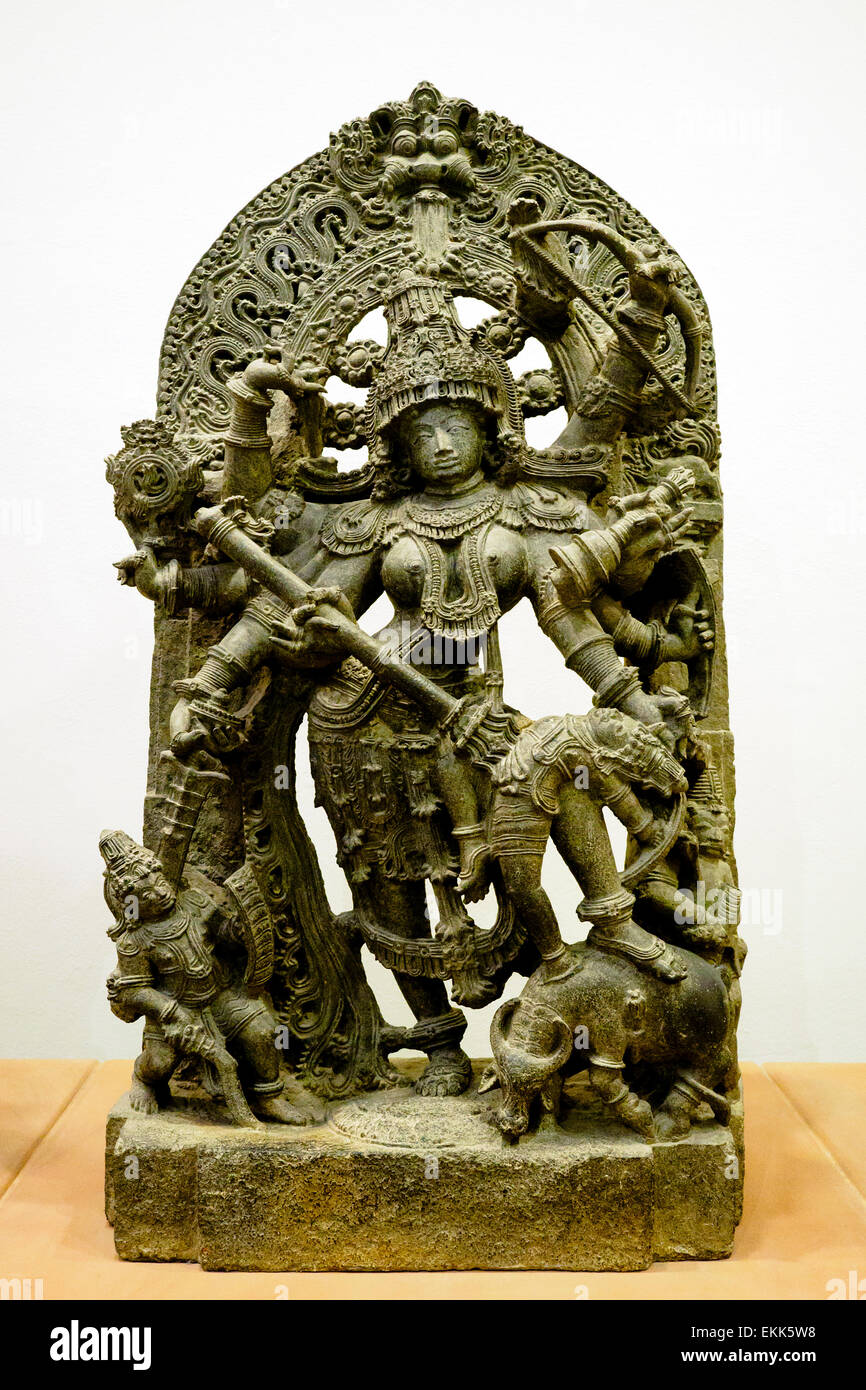 Durga as Mahisasuramardini about 1240-60 Hoysala period The goddess Durga represents the shakti of female energy of the god Shiva. Her eight arms wierld sacred weapons against the forces of evil. Metamorphosed impure limestone South West India (Hassan district, Karnataka, Deccan) Stock Photo