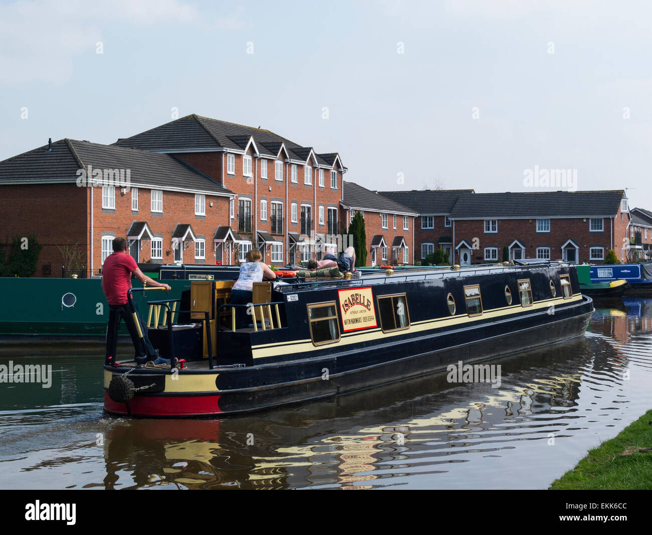 Narrowboat travelling along Shropshire Union Canal at small market town