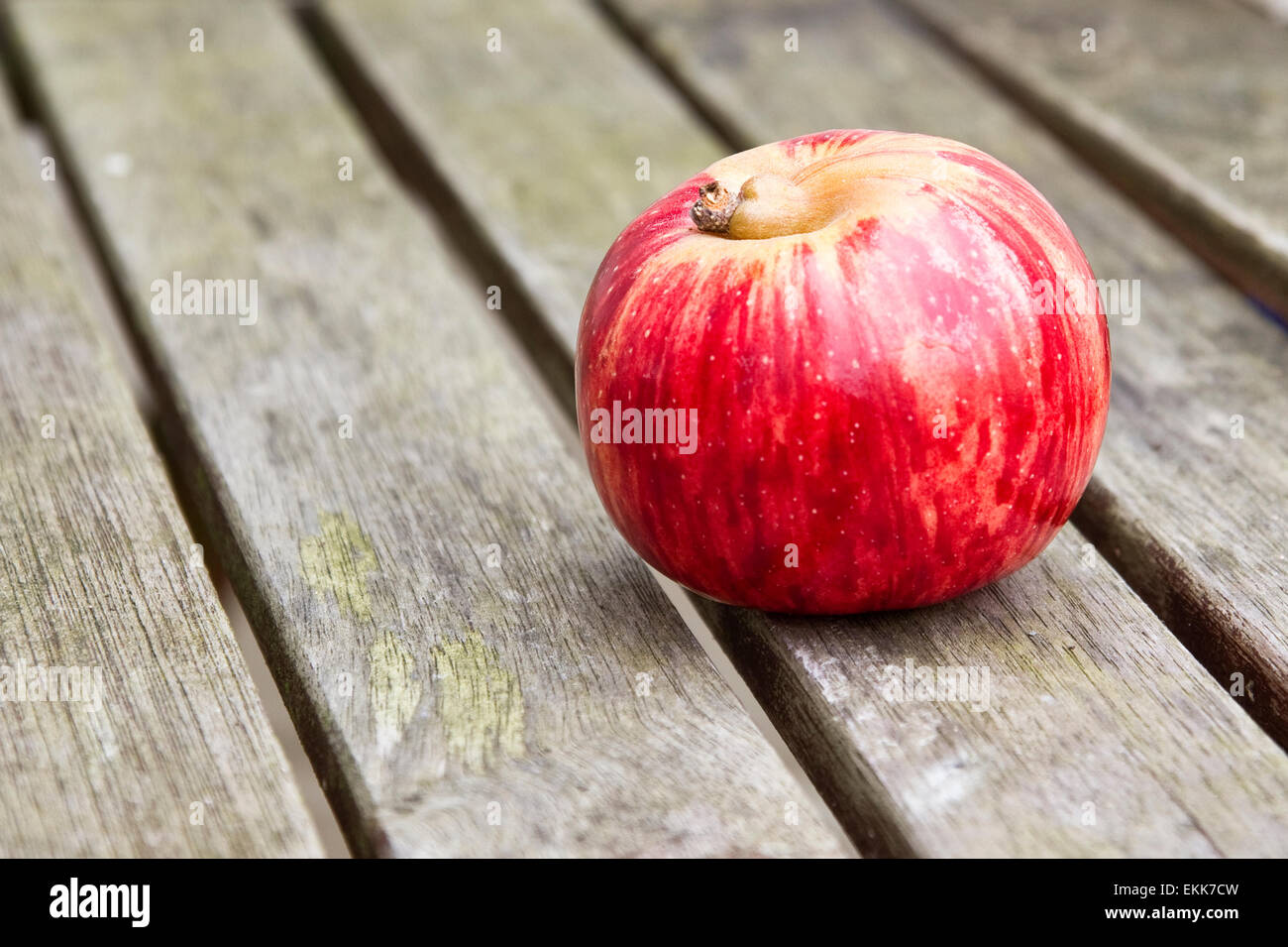 Red Apple on Wooden Table Stock Photo