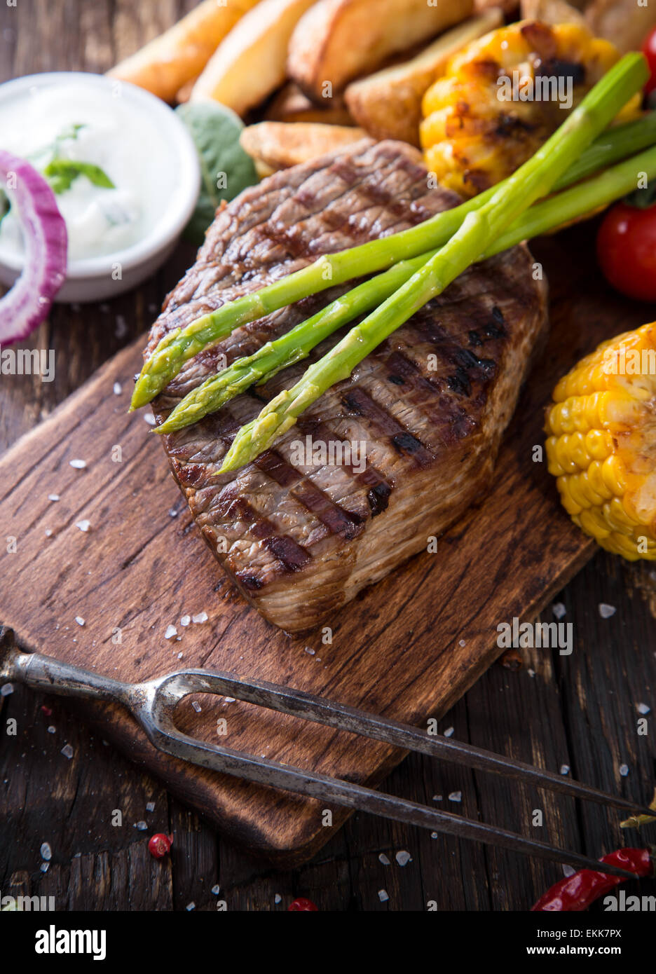 Delicious beef steak on wooden table, close-up Stock Photo