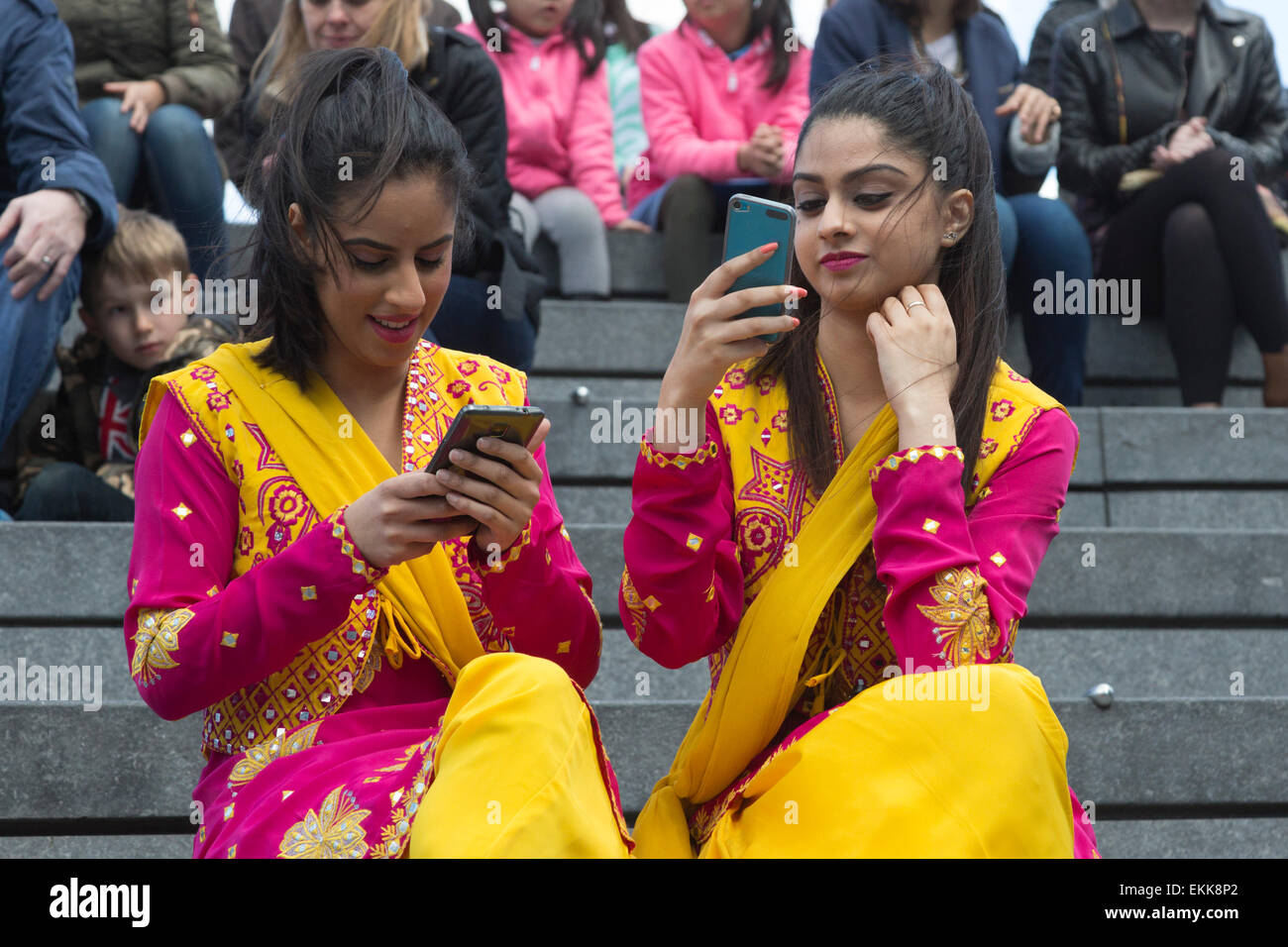 London, UK. 11 April 2015. Female dancers from VP Entertainment take selfies before their show at the Scoop. The Vaisakhi Festival takes place at in and around London's City Hall. Vaisakhi is the most important day in the Sikh calendar, commemorating the beginning of Sikhism as a collective faith. Photo: Nick Savage/Alamy Live News Stock Photo