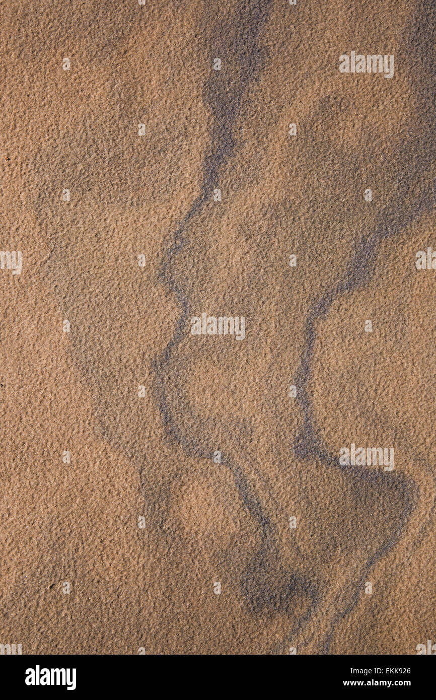 Natural patterns on sandy surface of the beach Stock Photo