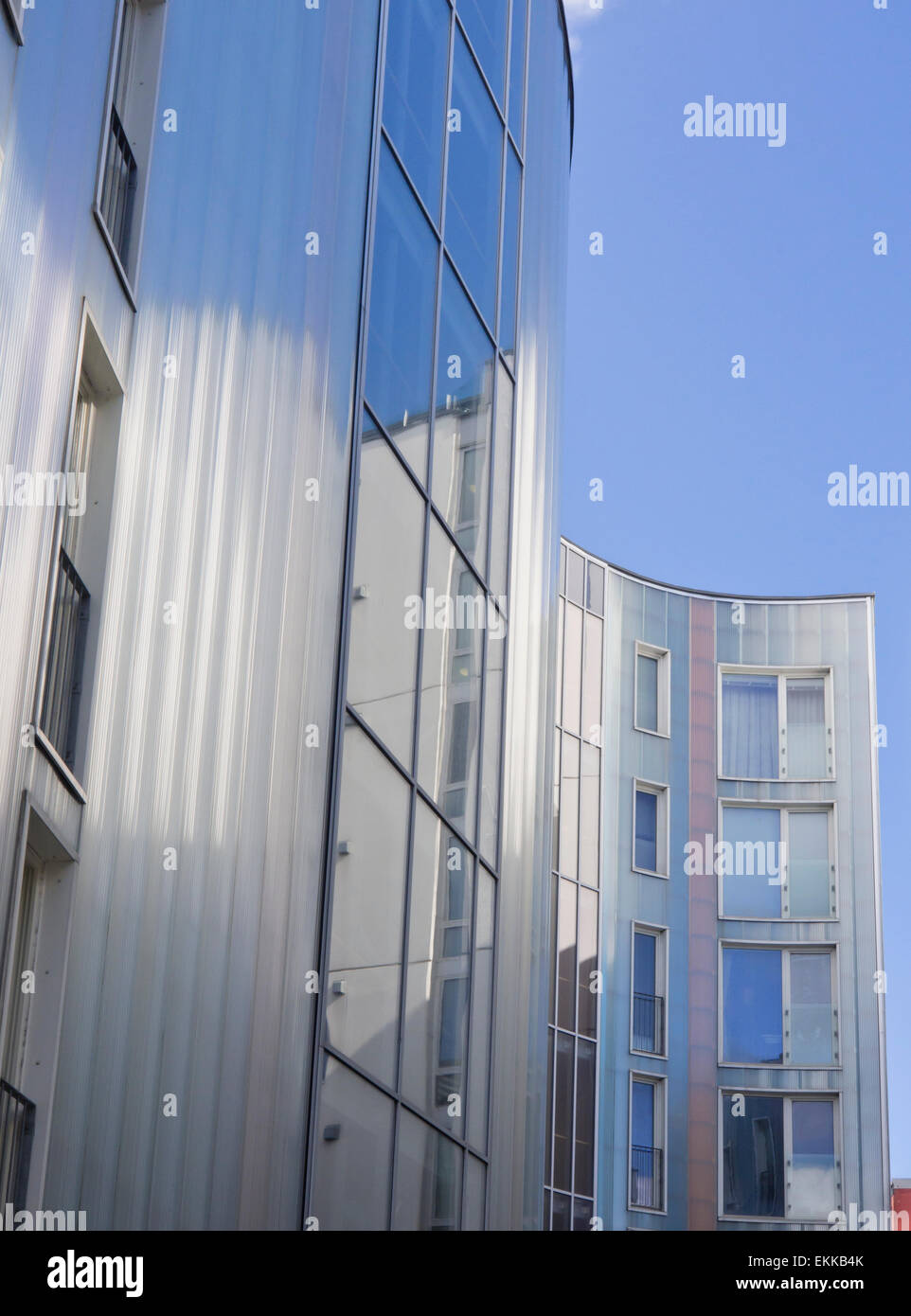 Curved shapes, facade reflecting the sky and weather, modern apartment block in the center of Stavanger Norway Stock Photo