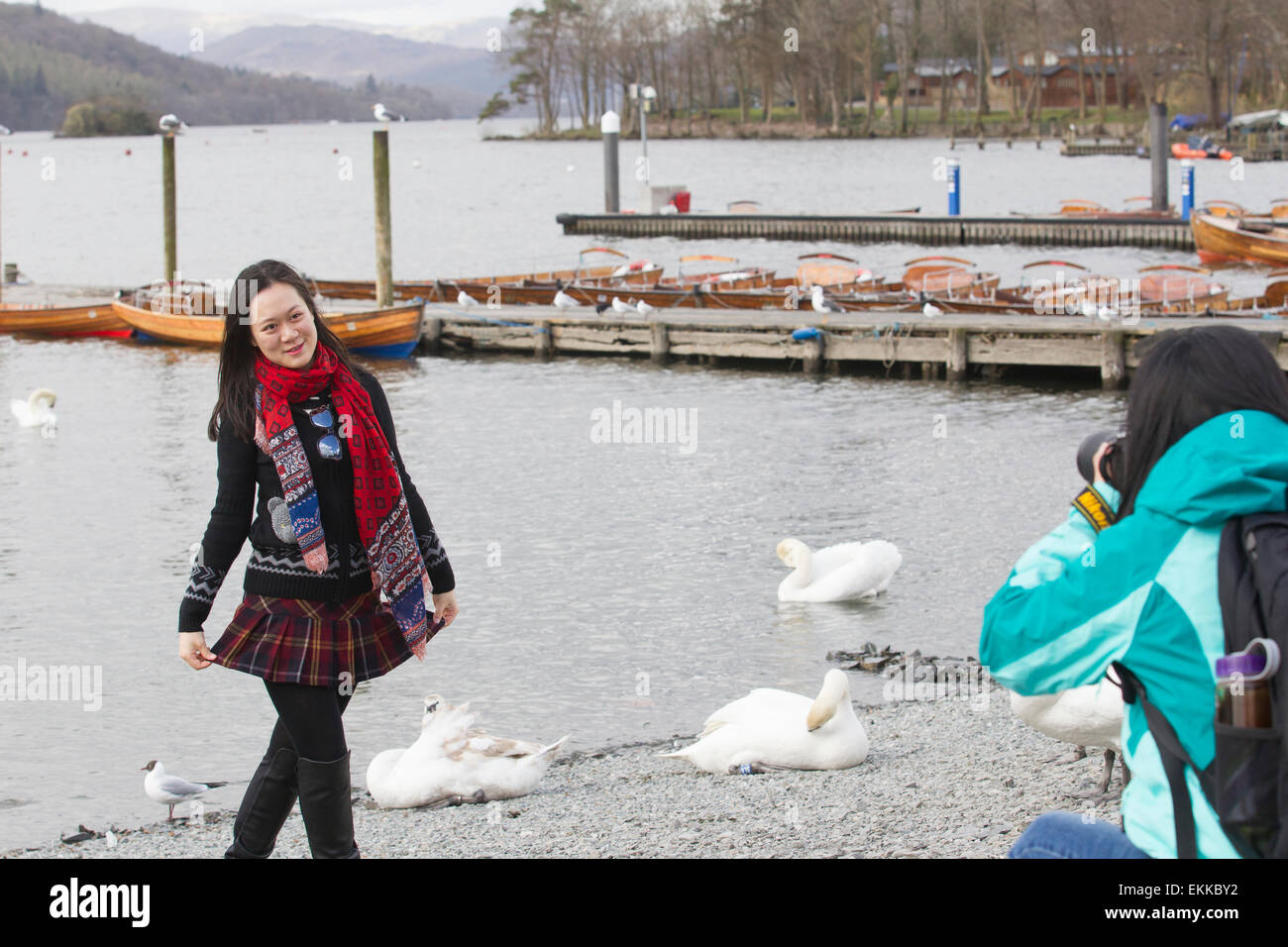 Lake Windermere Cumbria  11th April 2015 UK Weather Chinese tourists make the most of cold windy day posing for souvenir photos by the lake at Bowness Bay on Lake Windermere  Credit:  Gordon Shoosmith/Alamy Live News Stock Photo