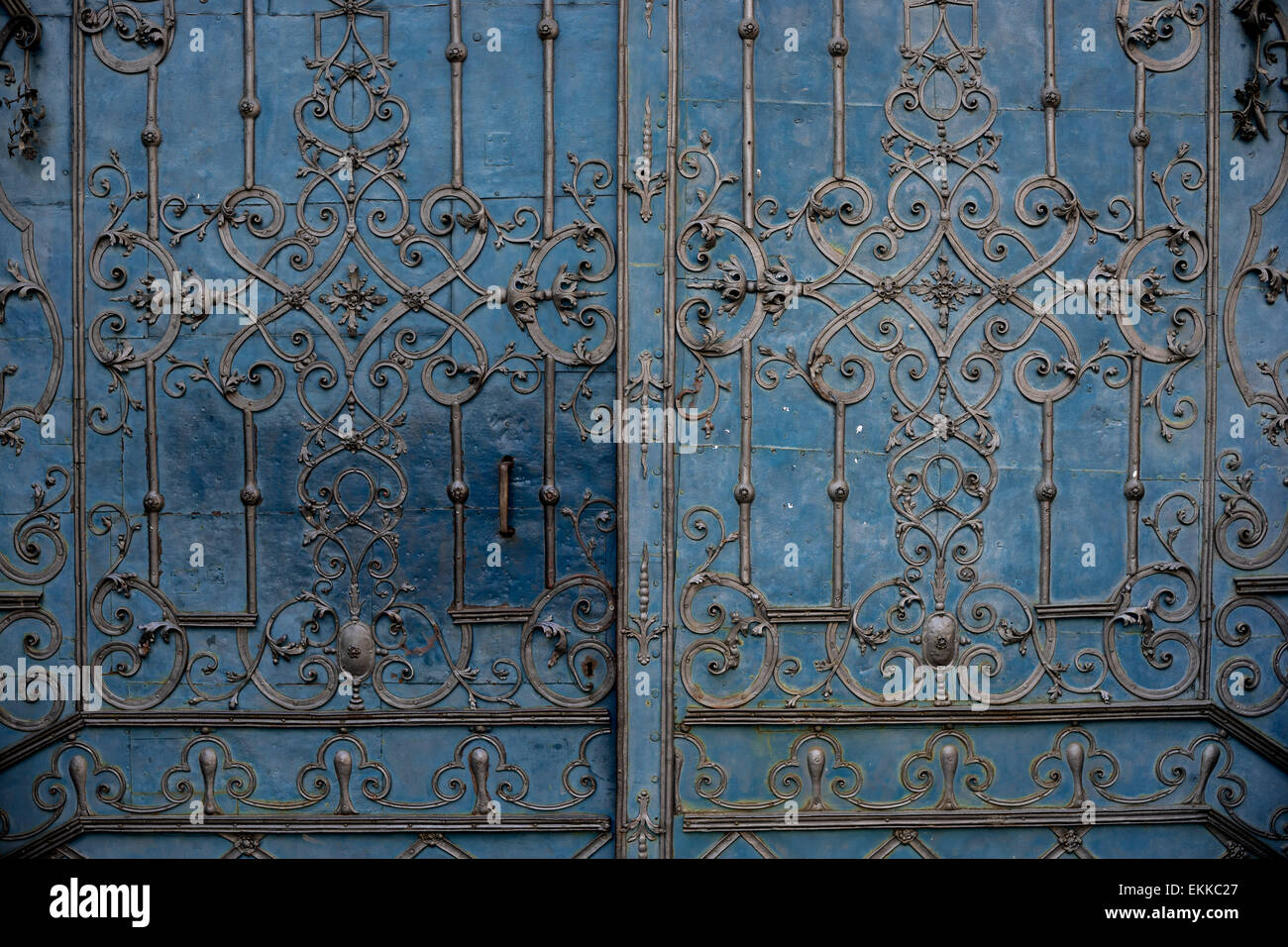 Old ornamented iron door painted in blue Stock Photo