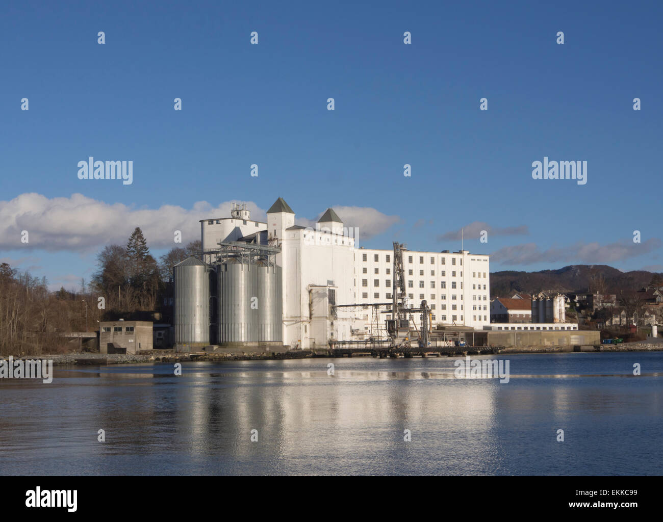 Tou Mølle, grains mill in Tau a local community near Stavanger Norway,  reflected in the fjord water on a sunny day Stock Photo - Alamy