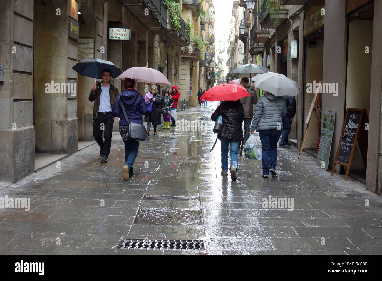 People with umbrellas on rainy day in Barcelona Stock Photo Alamy