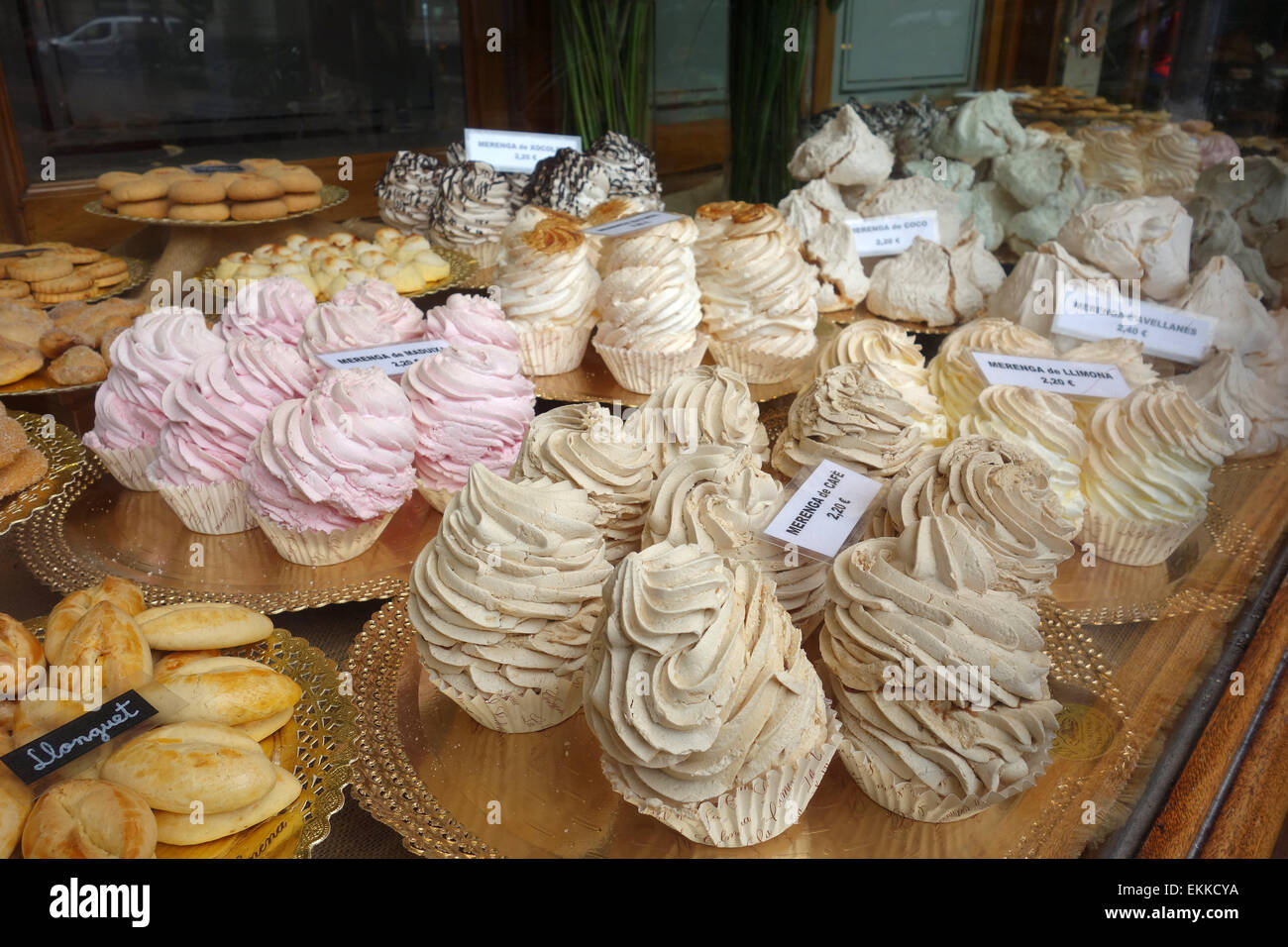 Meringues and cakes on display in window of traditional pastry shop La