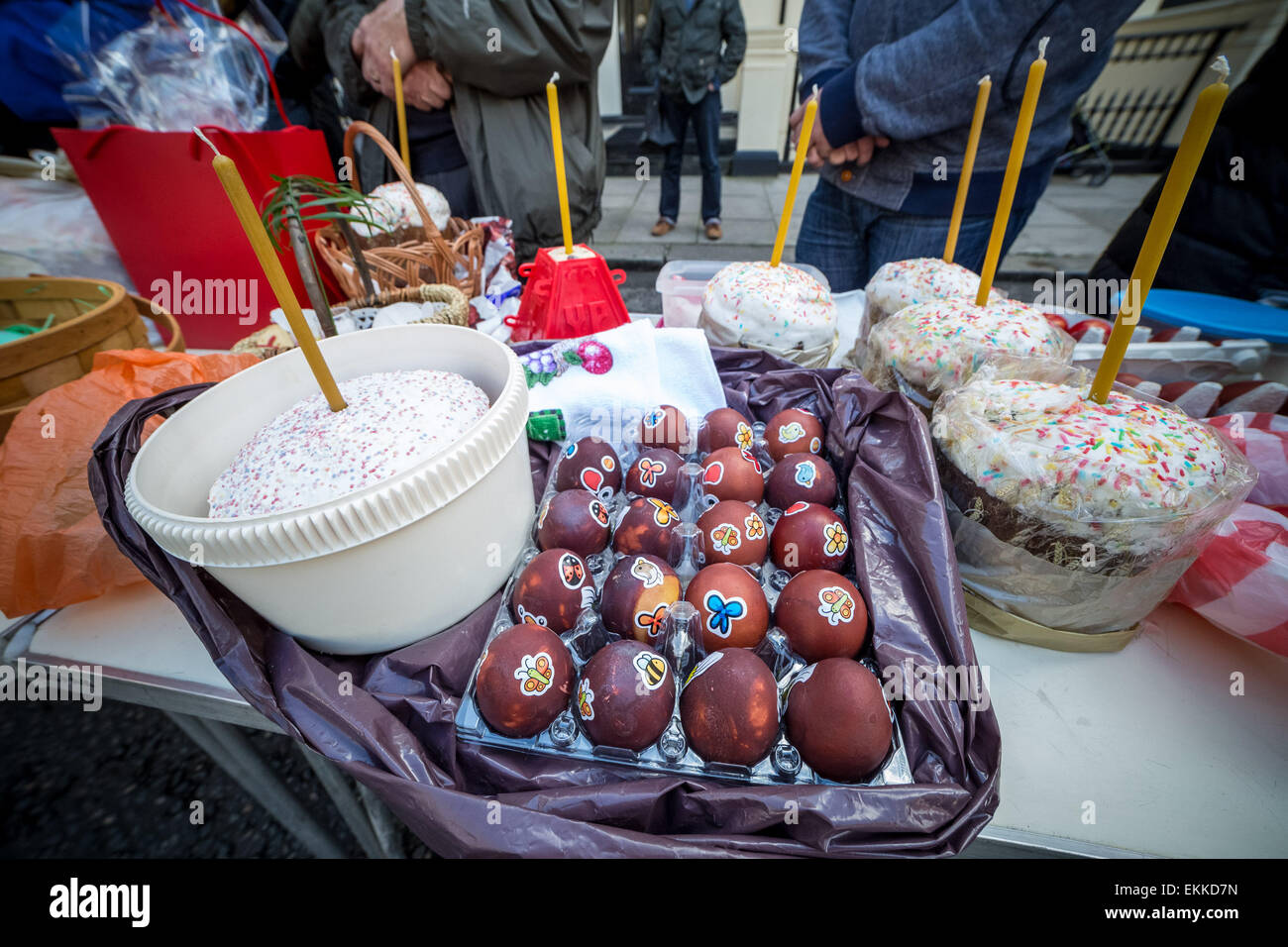 Orthodox Easter celebrations with decorated eggs, cakes and Pascha (Easter) baskets waiting to receive a holy water blessing on Great Saturday outside the Russian church (Diocese of Sourozh) in London, UK. Stock Photo