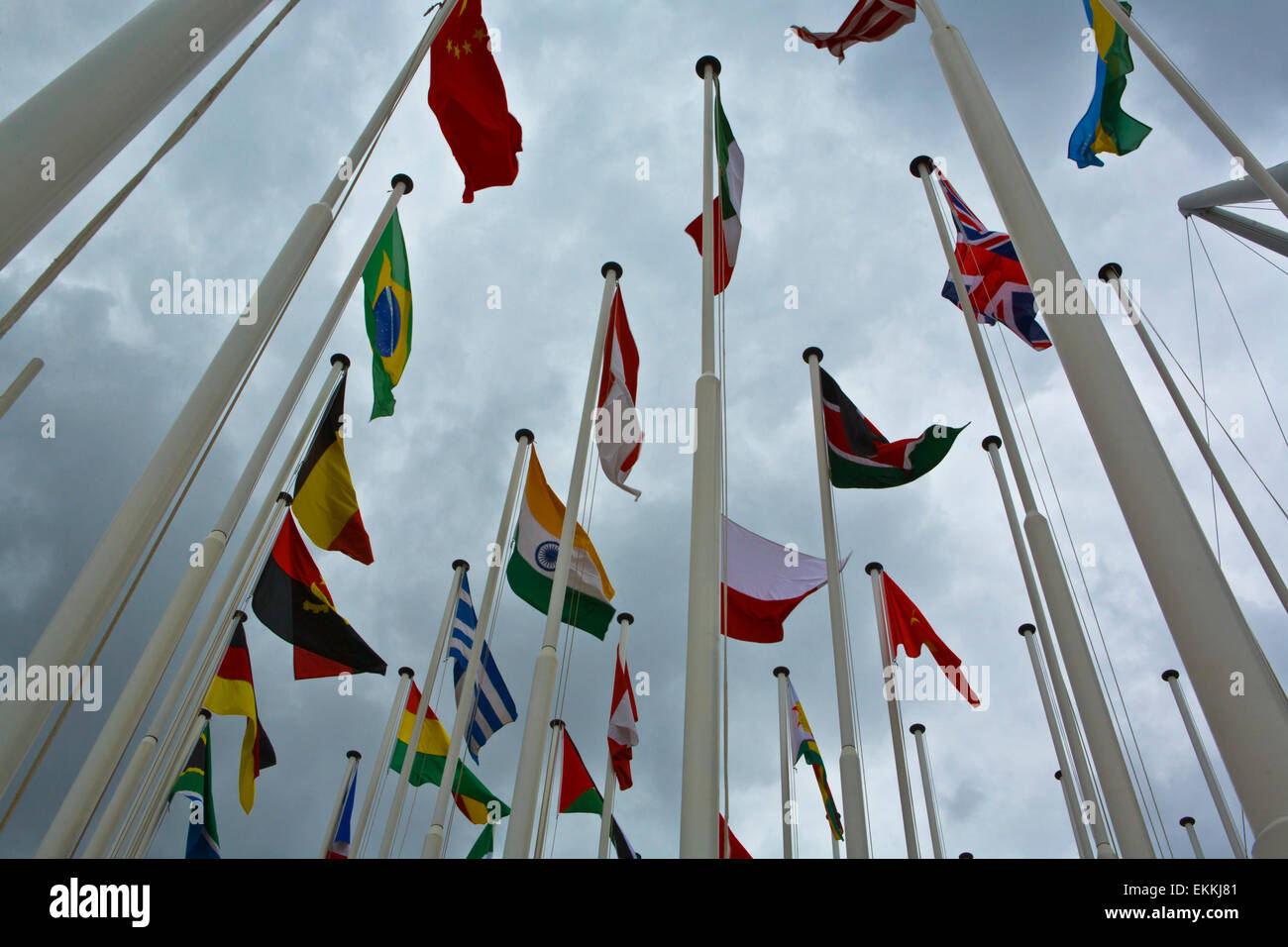 Flags of all nations of the world are flying in grey cloudy sky Stock Photo