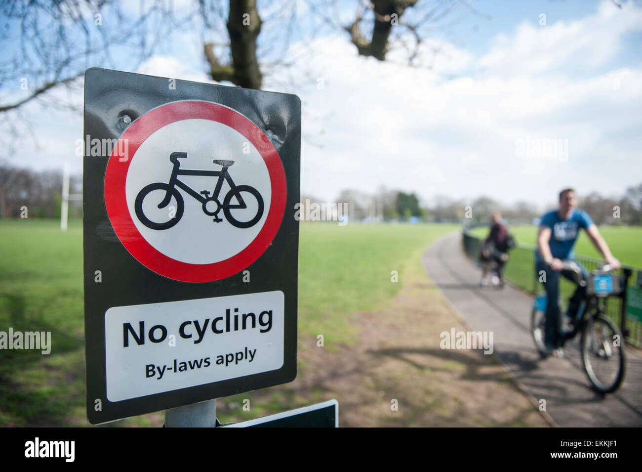 Cyclists ignore a no cycling road sign Stock Photo