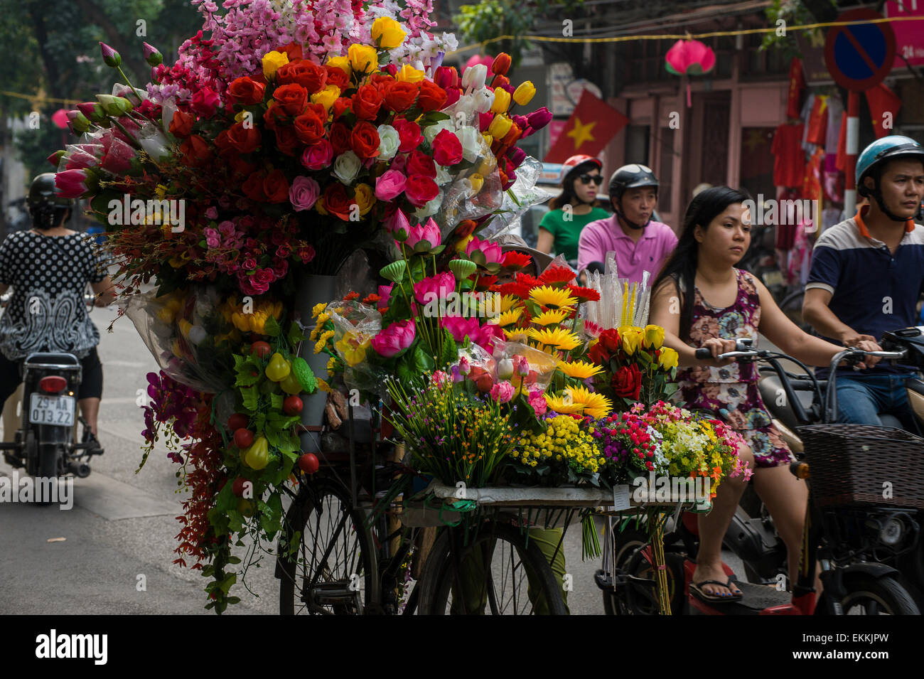a flower vendor walking through the streets of Hanoi, Vietnam Stock