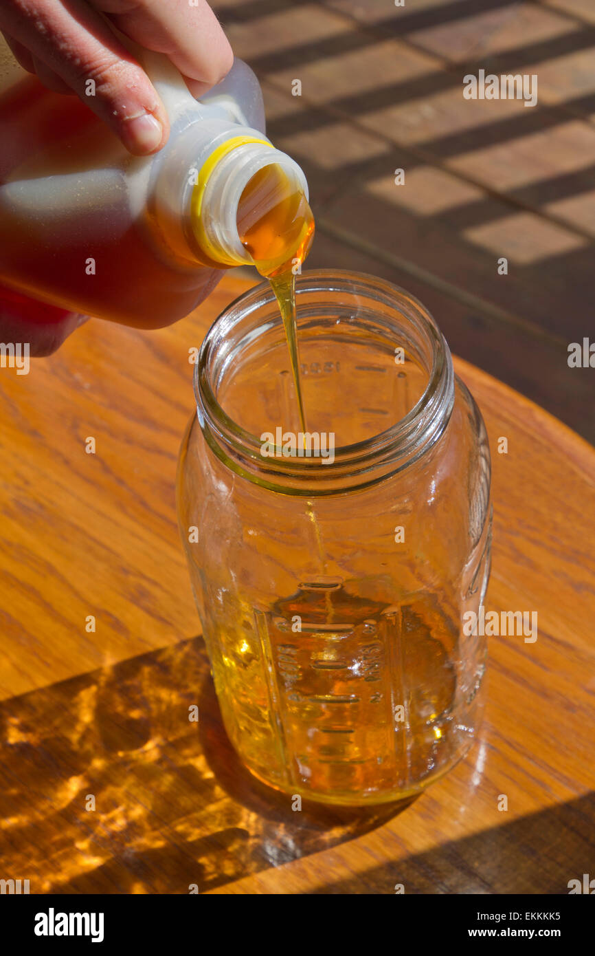 Download Close Up Of Someone Pouring Thick Golden Raw Honey From A Plastic Stock Photo Alamy PSD Mockup Templates