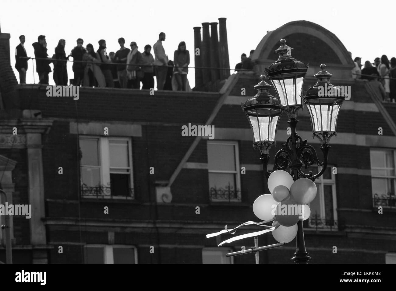 London, UK. 11th Apr, 2015. BNY Mellon Boat Races Day. Spectators standing on rooftops &amp; every possible vantage point to see the action Credit:  Action Plus Sports/Alamy Live News Stock Photo