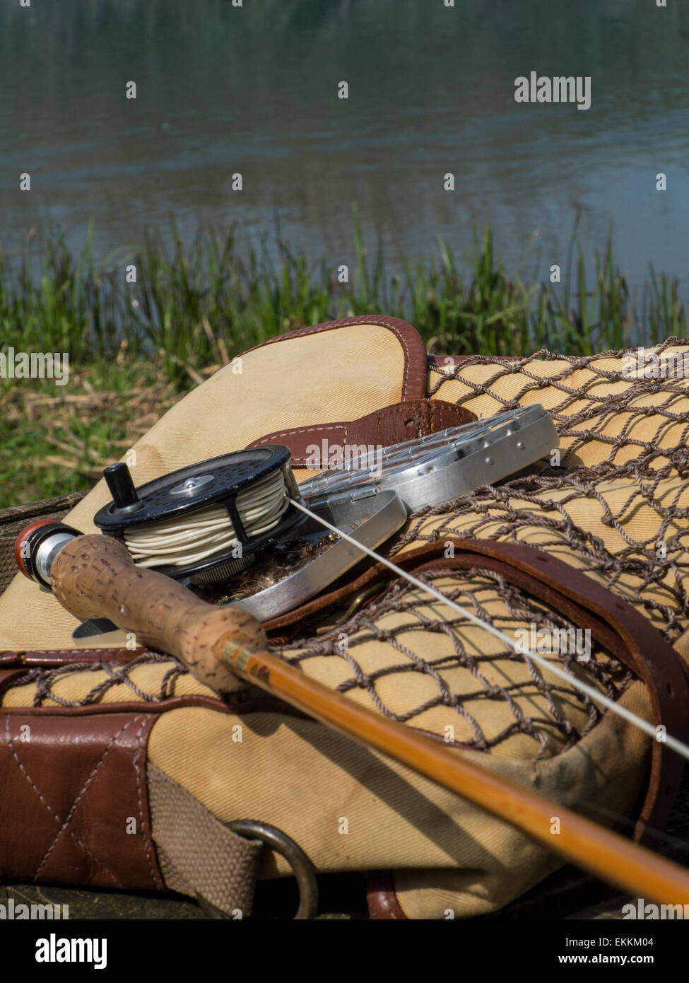 Traditional old vintage fly fishing tackle with the river in the background  Stock Photo - Alamy