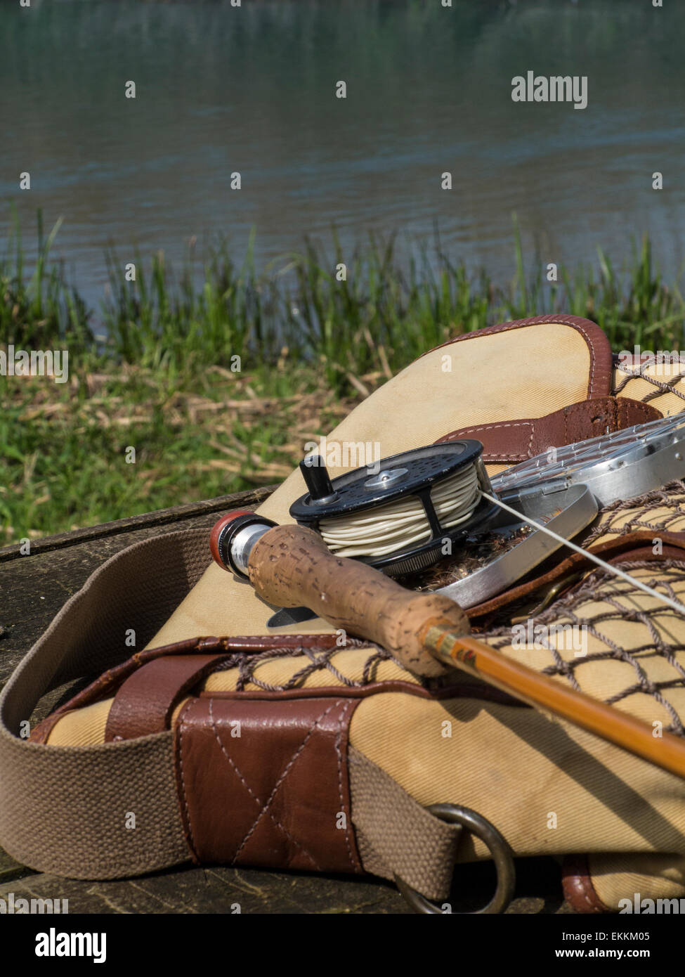 Traditional old vintage fly fishing tackle with the river in the background  Stock Photo - Alamy