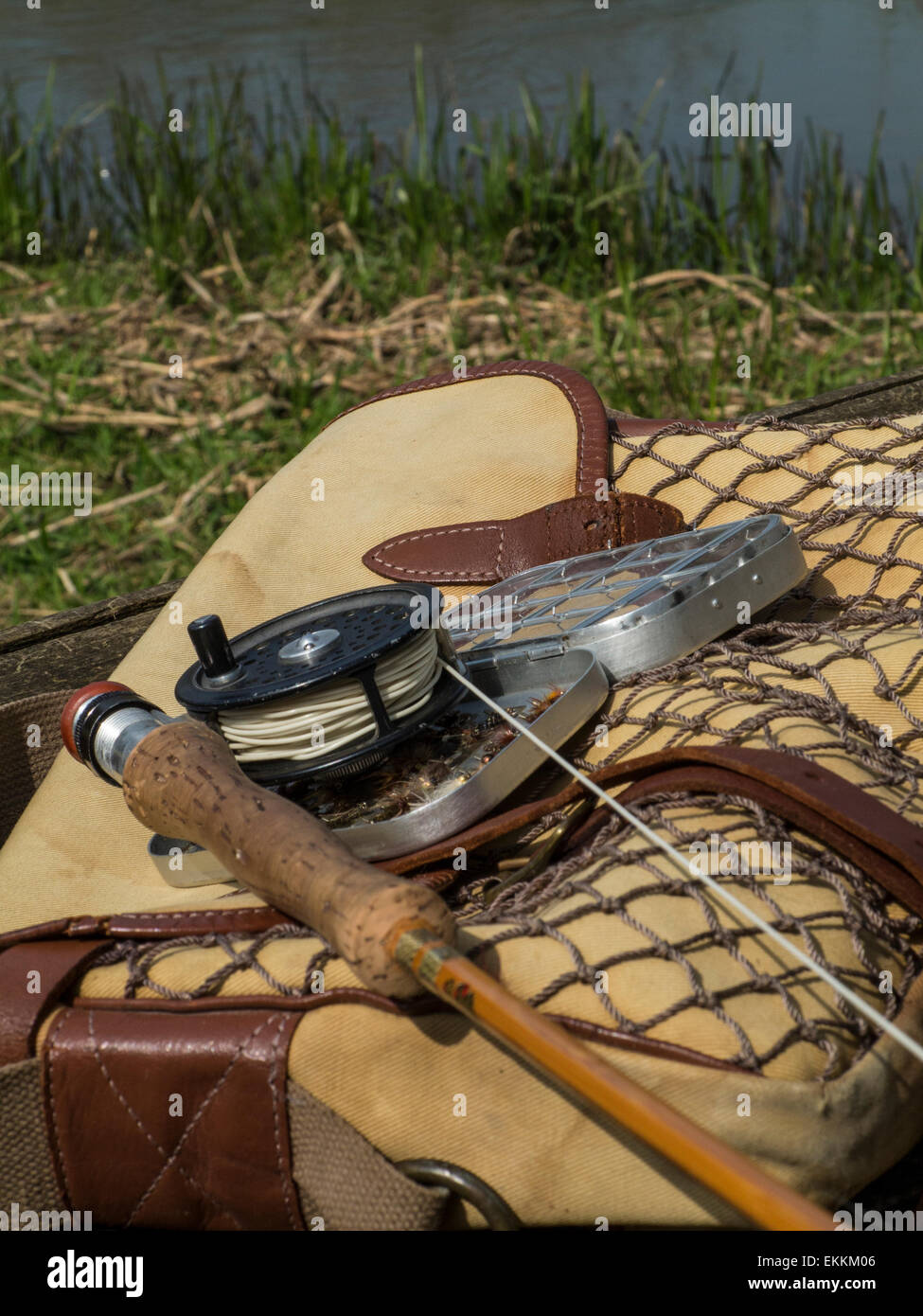 Traditional old vintage fly fishing tackle with the river in the background  Stock Photo - Alamy