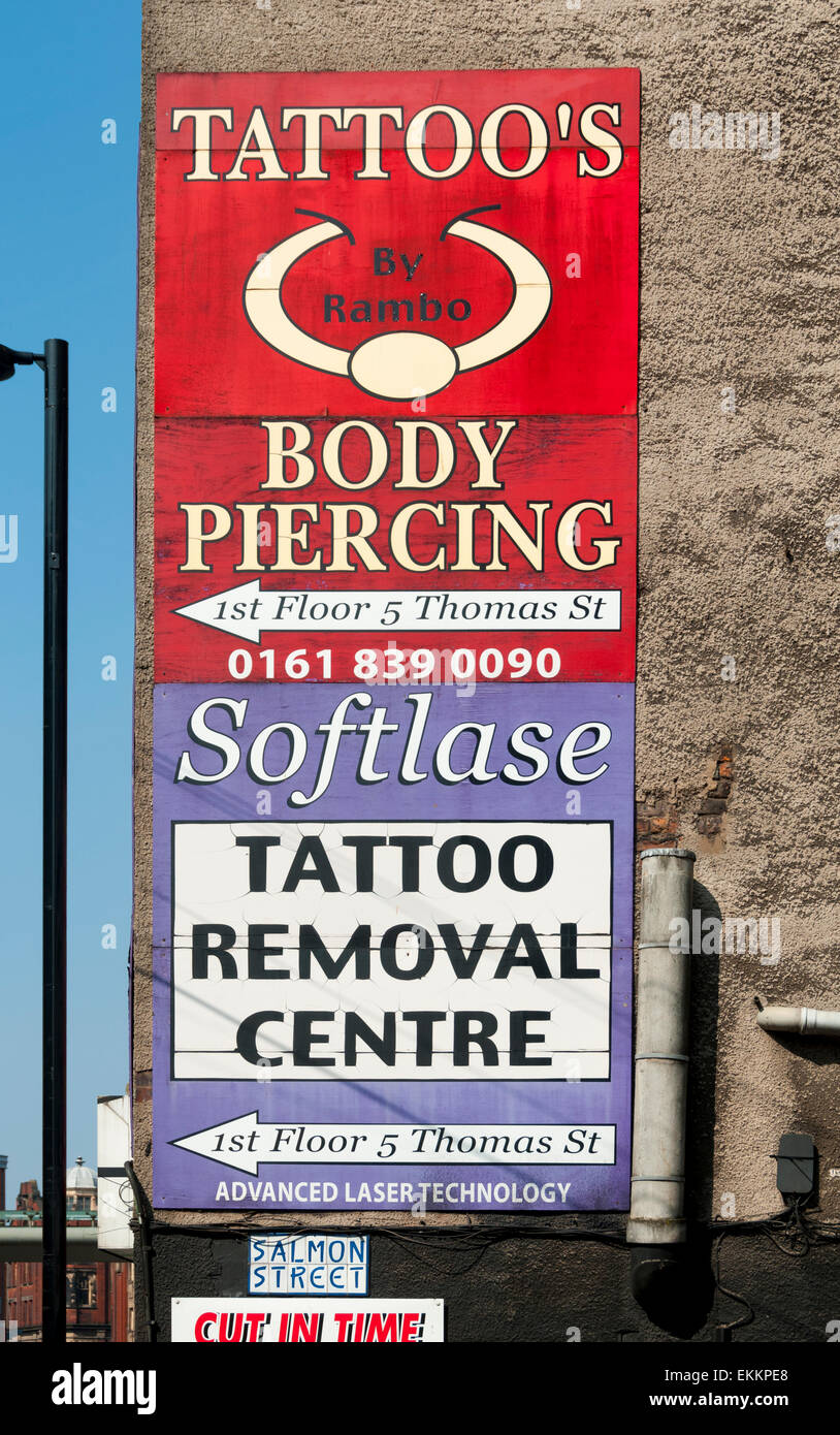 Tattoo and body piercing sign with misplaced apostrophe, Northern Quarter, Manchester, England, UK Stock Photo
