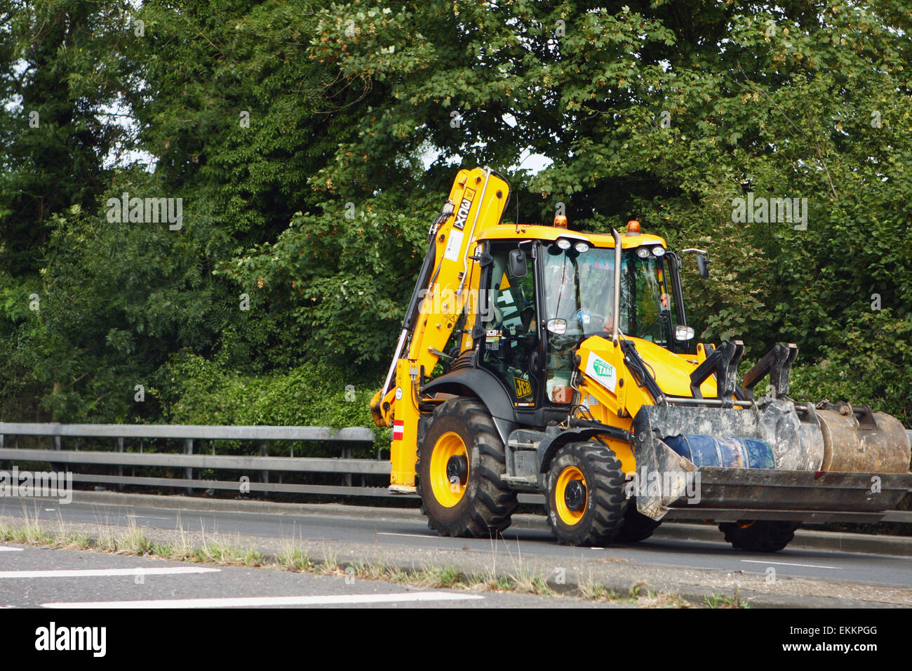 A JCB 3CX traveling along the A23 road in Coulsdon, Surrey, England. Stock Photo