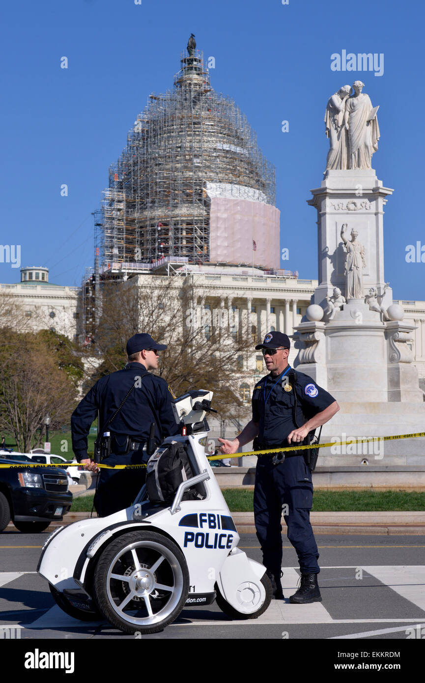Washington, DC, USA. 11th Apr, 2015. Policemen guard on Capitol Hill after a shooting in Washington, DC, the United States, April 11, 2015. Shots were fired on the West Front of the U.S. Capitol on Saturday leading to a security lockdown at the complex. "Confirmed: self-inflicted gunshot by neutralized subject," Capitol Police spokeswoman Kimberly Schneider said. Credit:  Yin Bogu/Xinhua/Alamy Live News Stock Photo