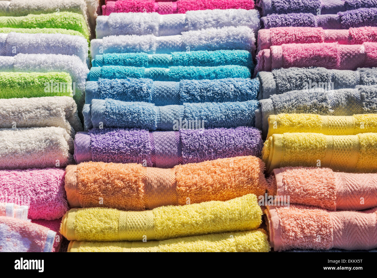 Colorful bath towels stacked on rows in market Stock Photo