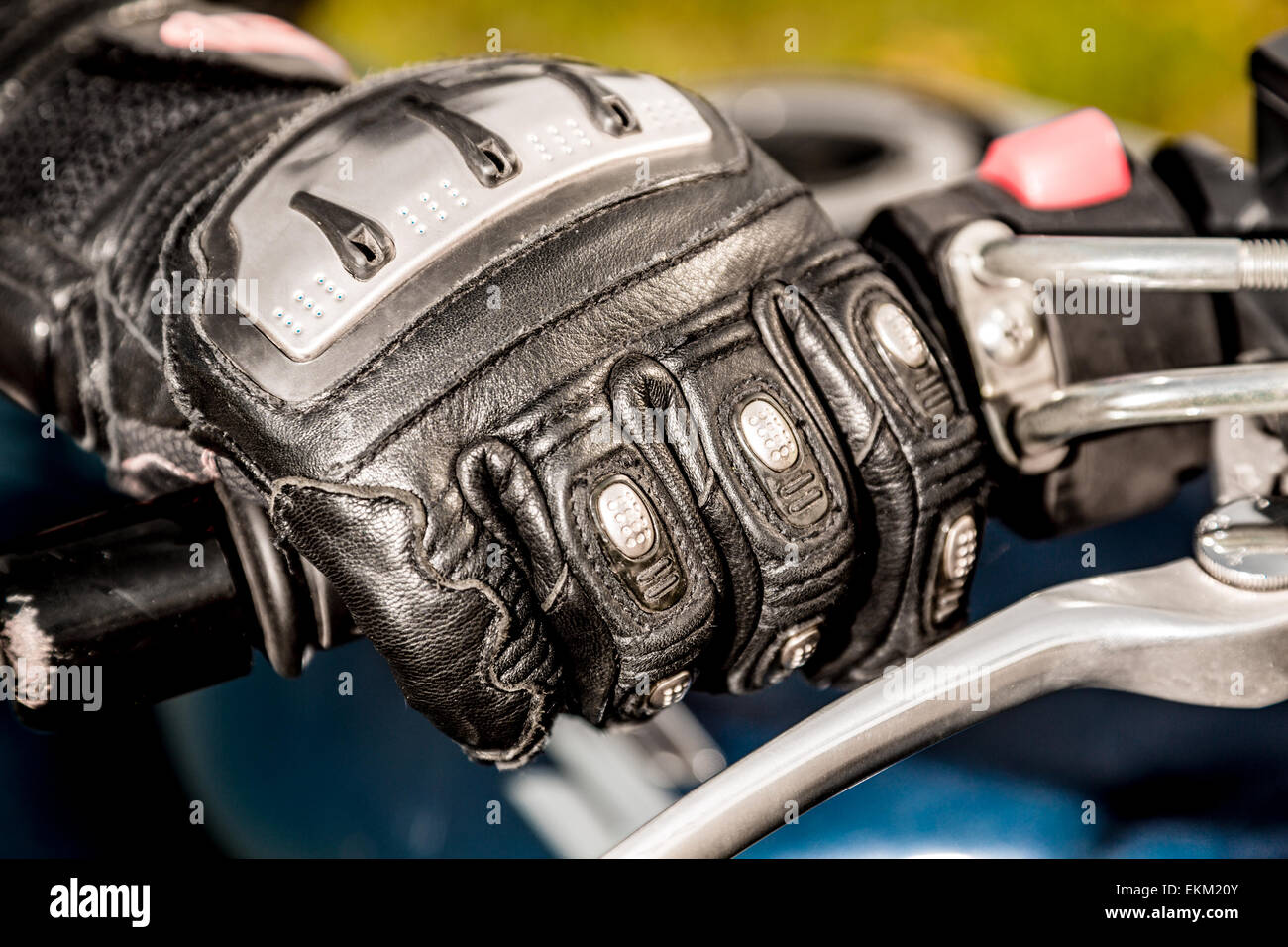Human hand in a Motorcycle Racing Gloves holds a motorcycle throttle  control. Hand protection from falls and accidents Stock Photo - Alamy