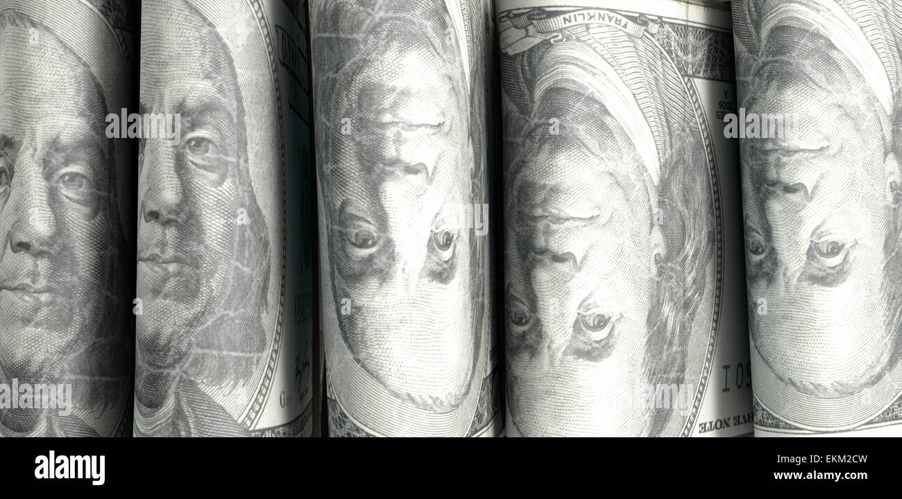 A close-up view of five wads of folded over stacks of us dollar ...