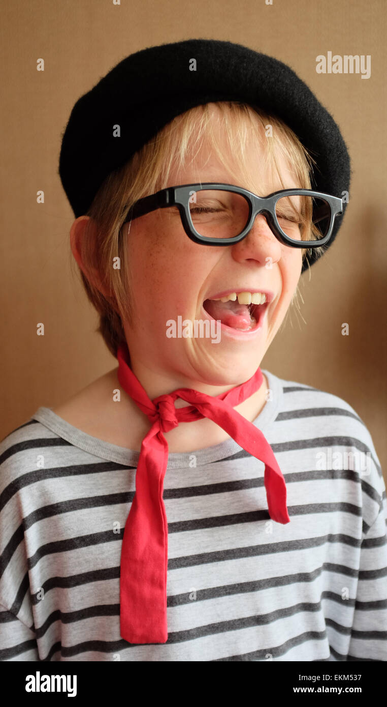 Laughing Child dressing up for a French day school project Stock Photo