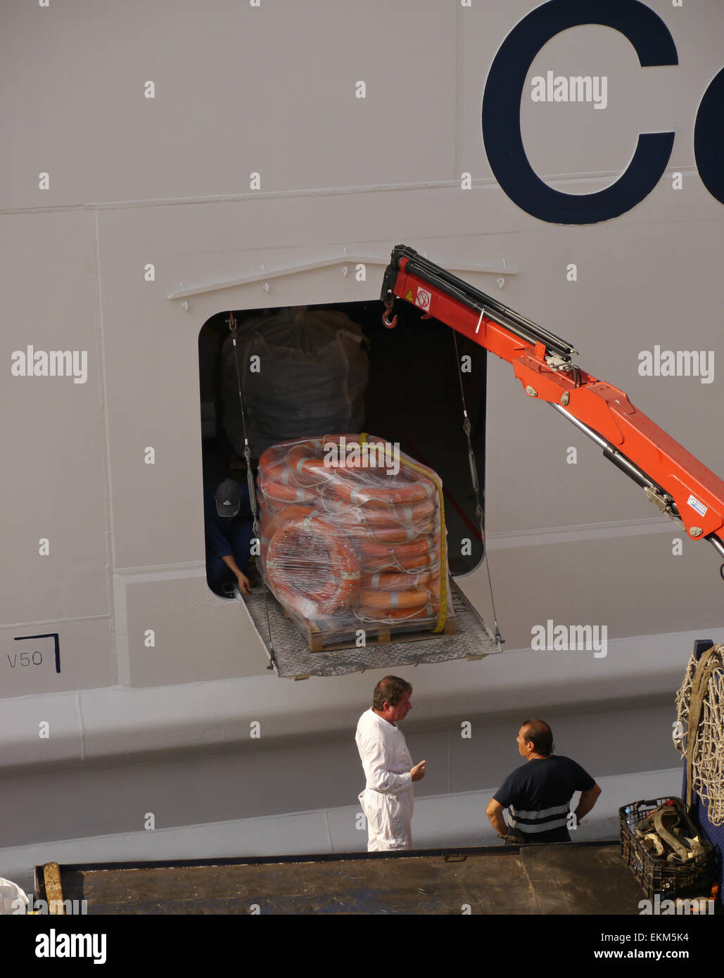 Dockside view of Celebrity Equinox cruise ship with a pallet of life rings being loaded. Stock Photo