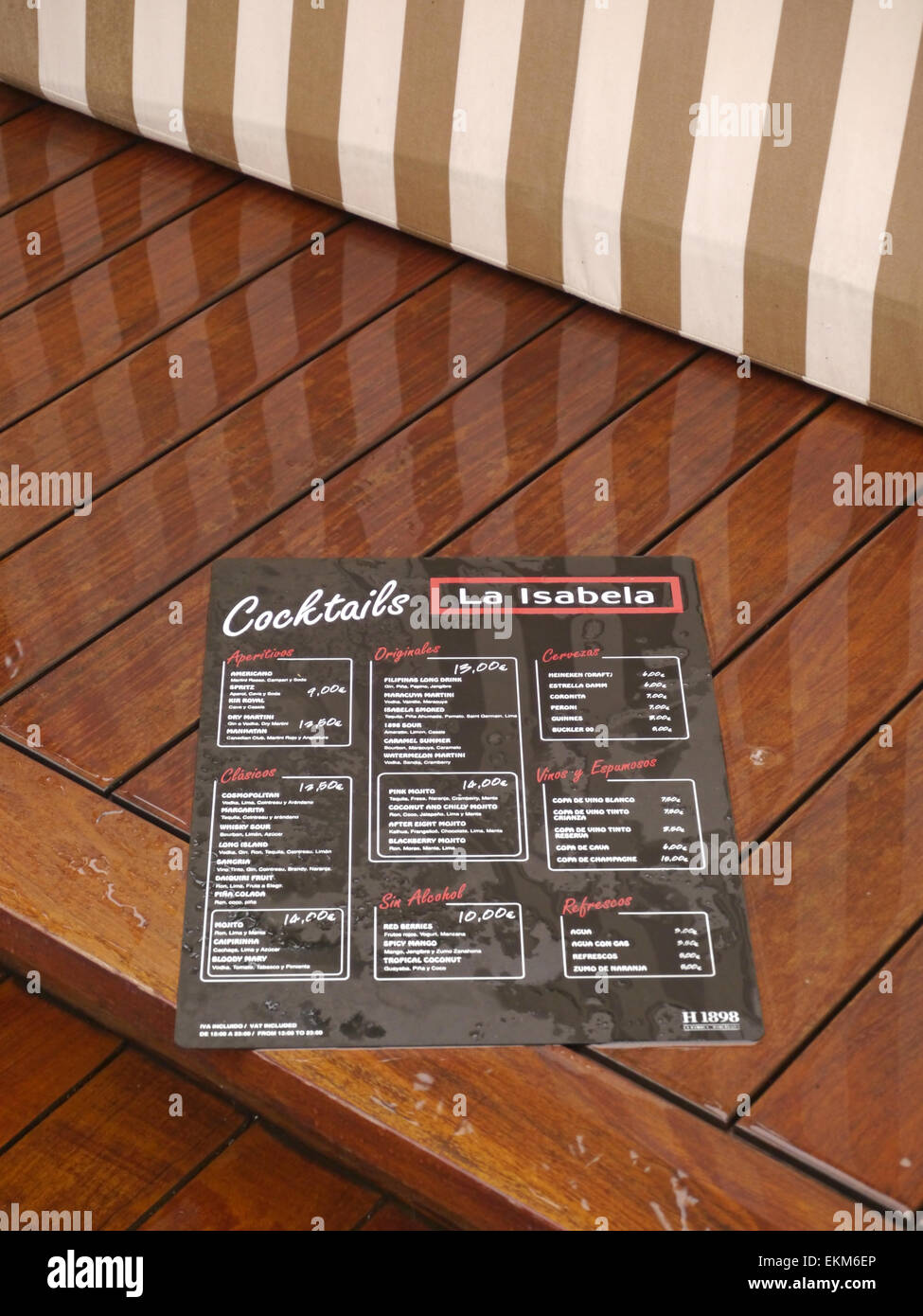 A Cocktail Menu Lying On A Wet Bench Seat In The Rain Stock Photo