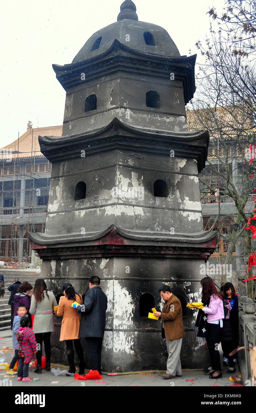 Sui Ning, China:  Chinese Buddhists queue at a ceremonial paper burning pagoda at the Lin Quan Si Temple  * Stock Photo