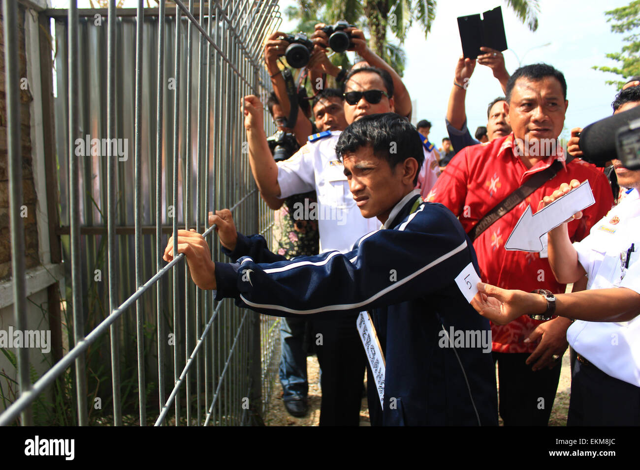 Pekanbaru, Riau, Indonesia. 10th Apr, 2015. RIAU, INDONESIA - APRIL 12: Mario Steven Ambarita escorted by Indonesia Police reset on the air infiltration case at Sultan Syarif Kasim II airport on April 10, 2015 in Pekanbaru, Indonesia. Mario Steven Ambarita has suspect for violating the Aviation Law due to reckless action broke into Sultan Syarif Kasim II Airport and infiltrate into the rear wheels Garuda Indonesia to Jakarta. © Sijori Images/ZUMA Wire/Alamy Live News Stock Photo