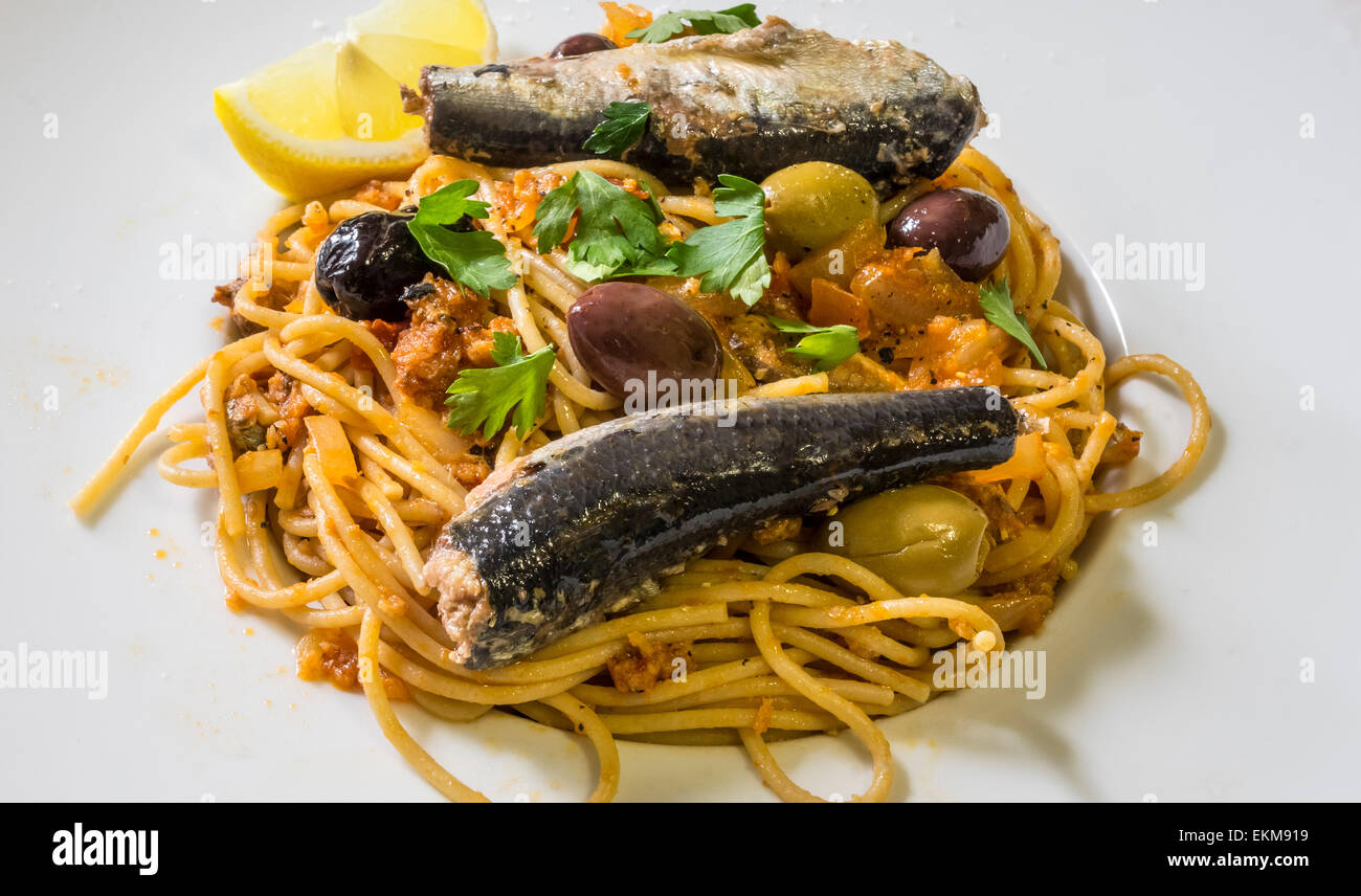 Spaghetti with sardines and olives, a classic Sicilian dish Stock Photo Alamy