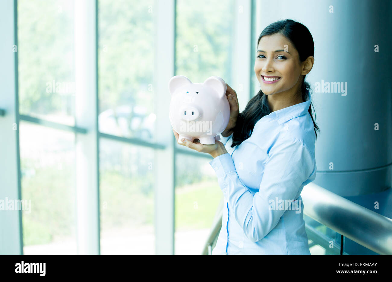 Closeup portrait happy, smiling business woman, holding pink piggy bank ...