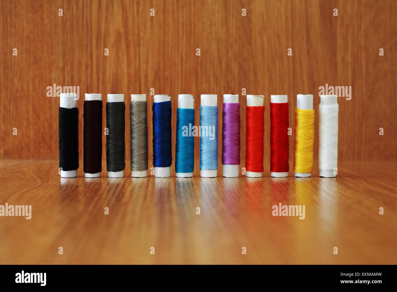 Skein of colored thread on a brown wooden background Stock Photo