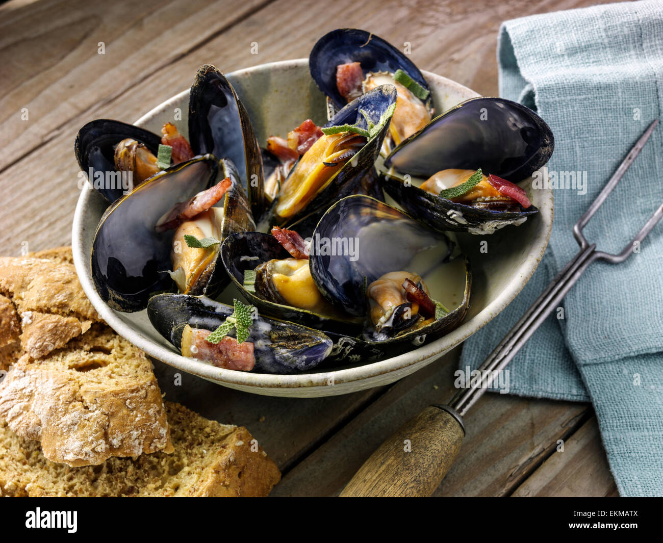 Mussels with cider and smoky bacon Stock Photo