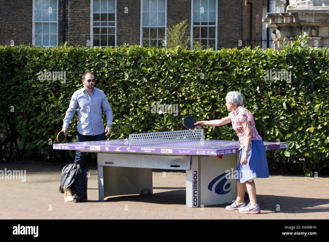 Playing table tennis in the park at lunch time hires stock photography