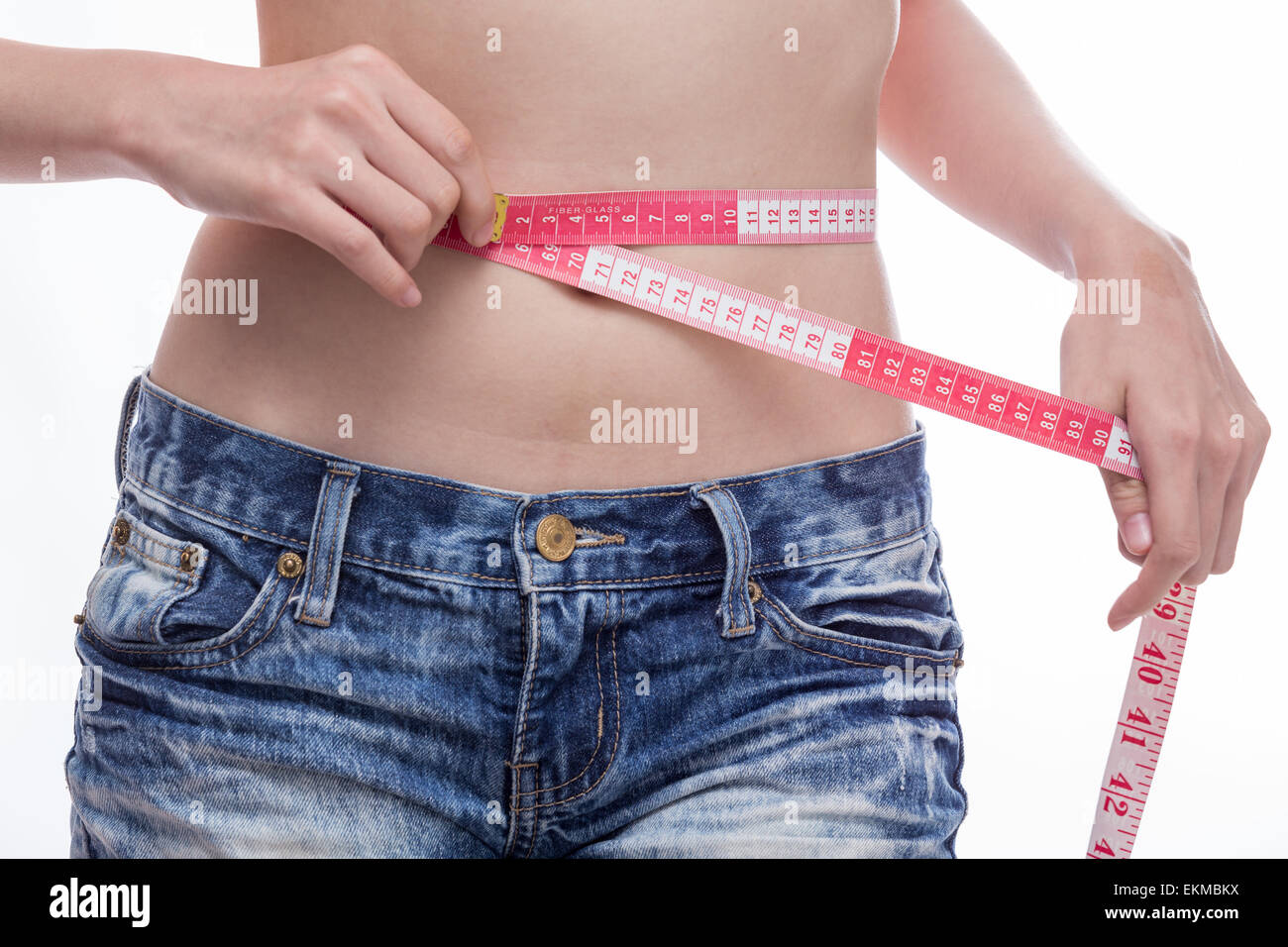 Woman checking stomach measurements with measuring tape Stock Photo Alamy