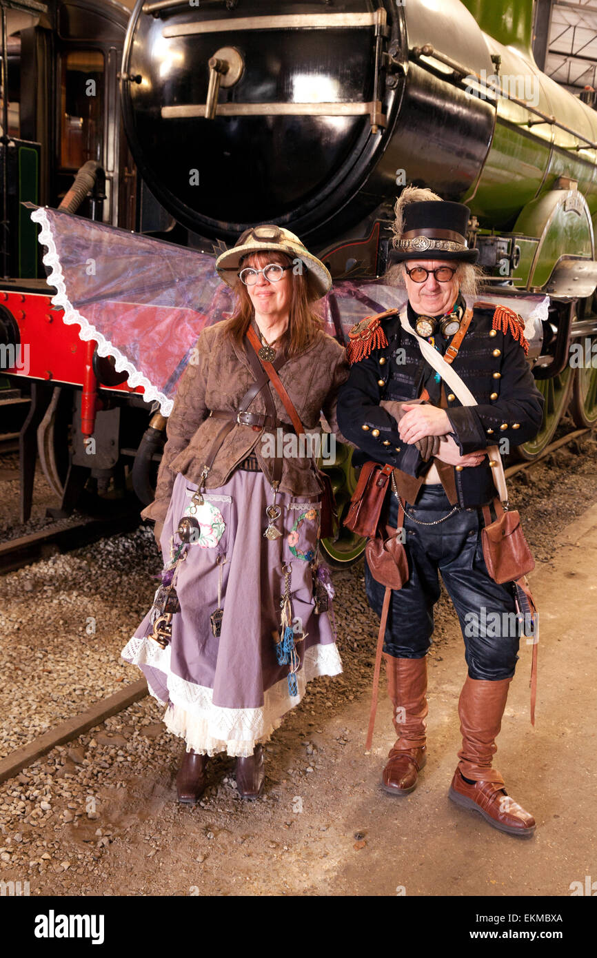 Bressingham, Norfolk, UK. 12th April, 2015. An east anglian steampunk couple in full costume at the Bres-Steam Steampunk Event, Bressingham Steam Museum, Bressingham, Norfolk, UK on Sunday 12th April 2015. Steampunk is a subgenre of science fiction and fantasy, and more recently a fashion movement which incorporates fashion and design with 19th century industrial steam powered machinery, and is becoming increasingly popular in the United Kingdom. Credit:  Kumar Sriskandan/Alamy Live News Stock Photo
