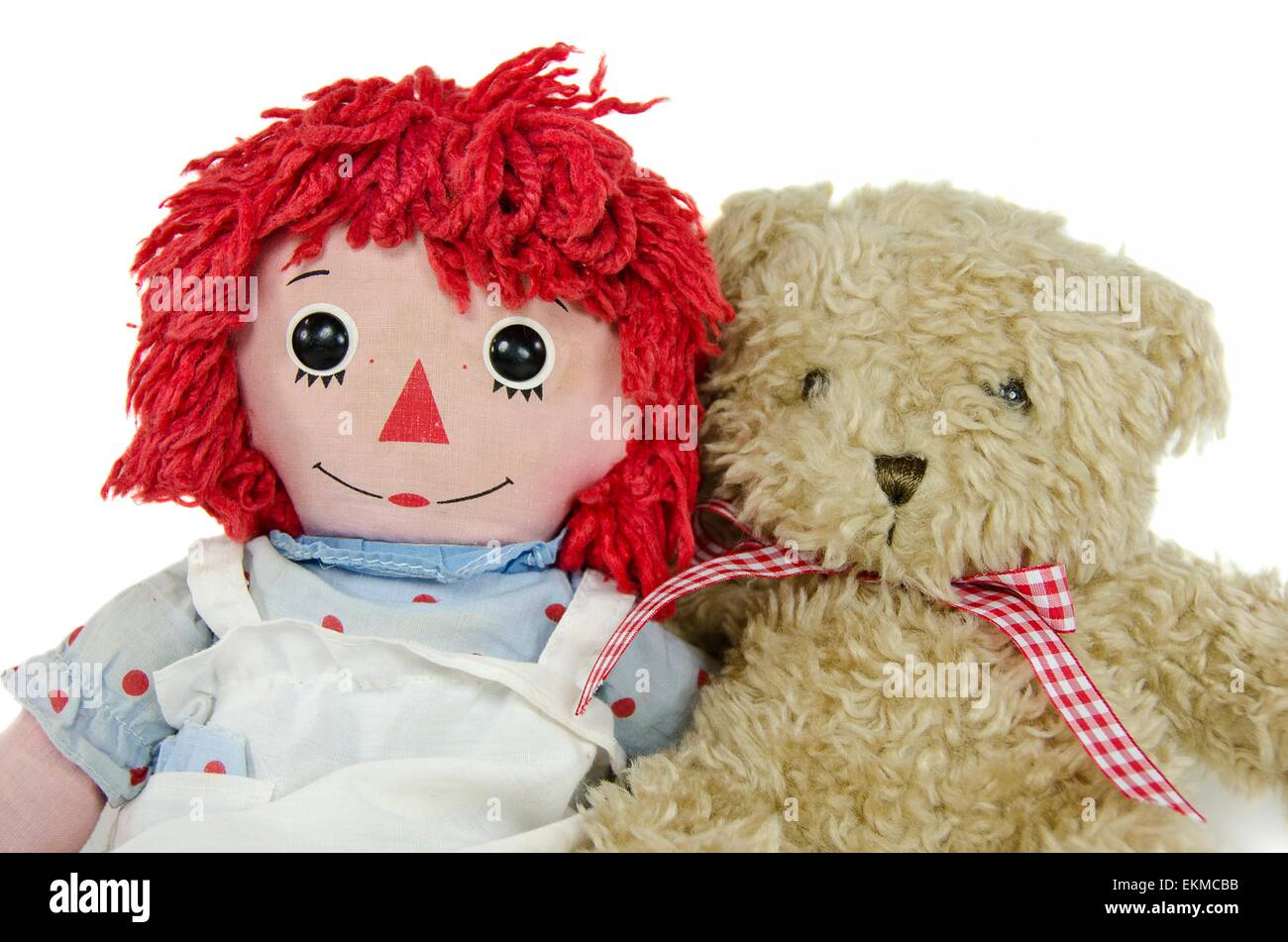Old rag doll with teddy bear isolated on white. Stock Photo