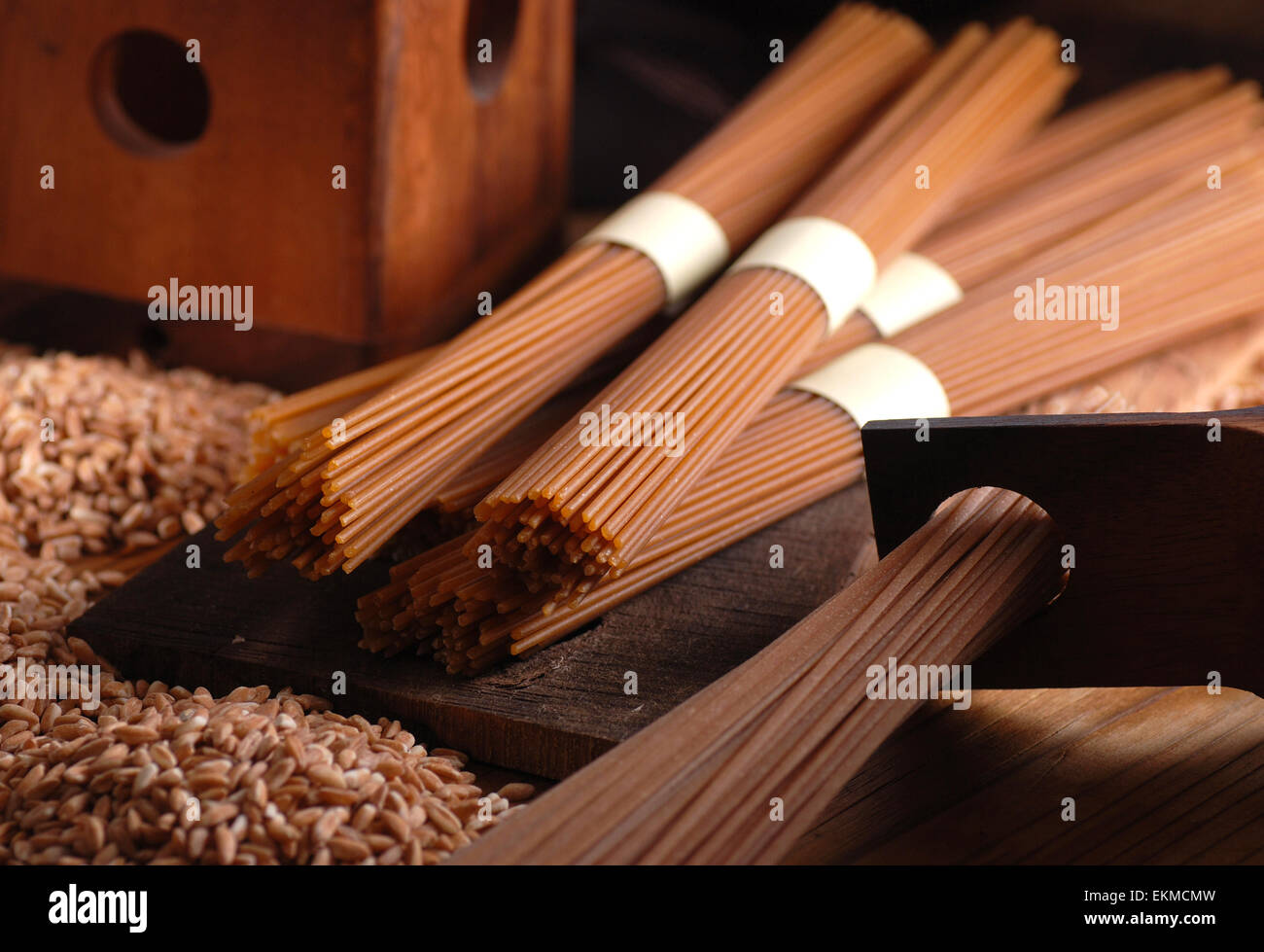 Organic wholemeal spaghetti pasta extruded through bronze Stock Photo