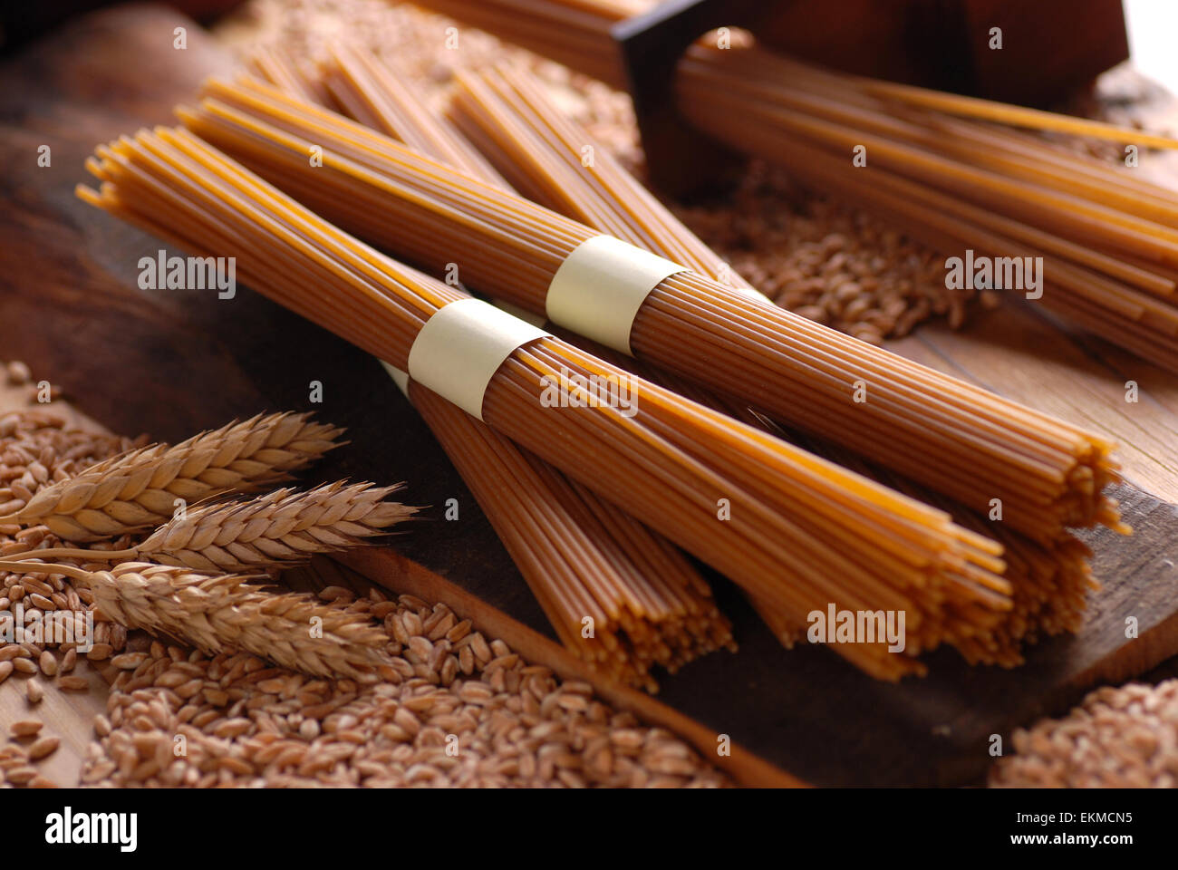 Organic wholemeal spaghetti pasta extruded through bronze Stock Photo