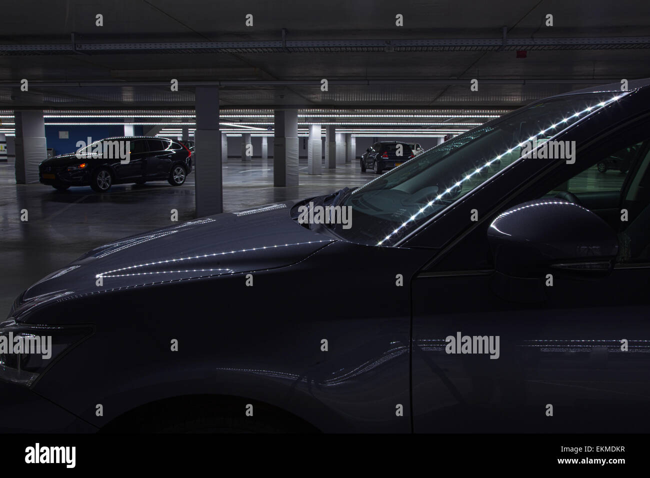 cars in spooky and dimly lit parking garage with strange lights Stock ...