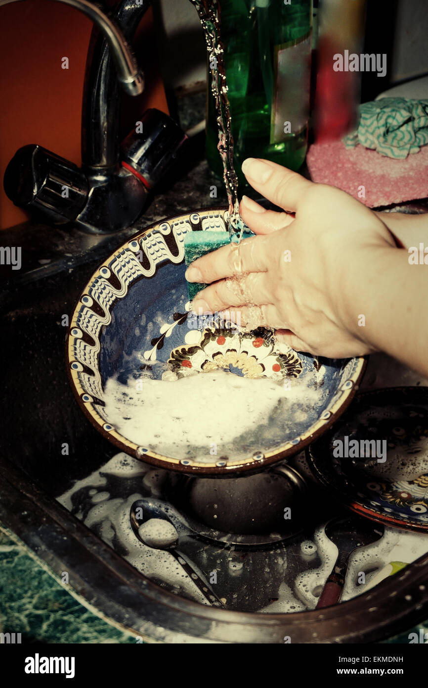 Retro photo housewife with washes ornamental  dishes toned colorized photo Stock Photo