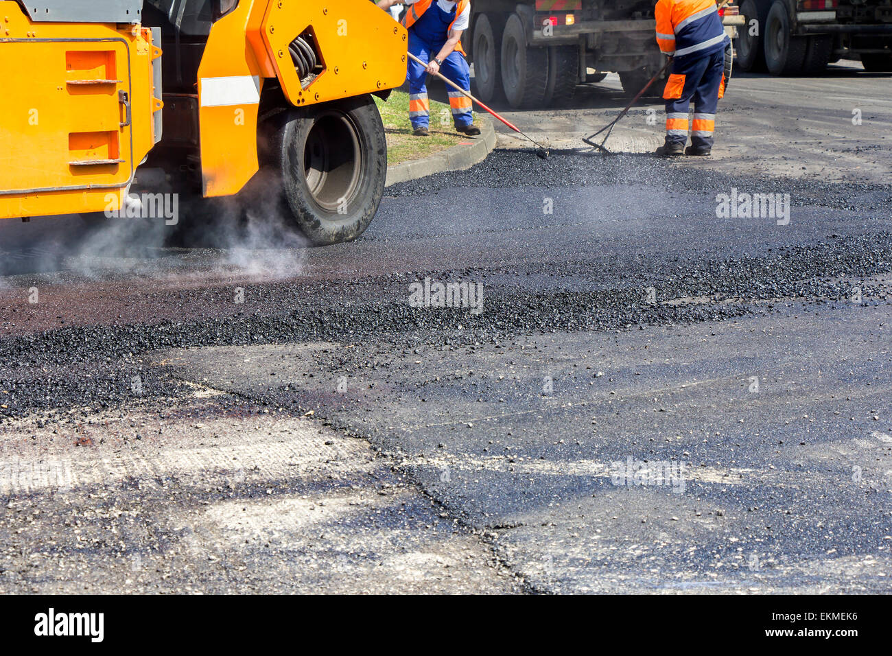 Asphalt Rool Work Roller and workers on asphalting and repair of city streets Stock Photo ...